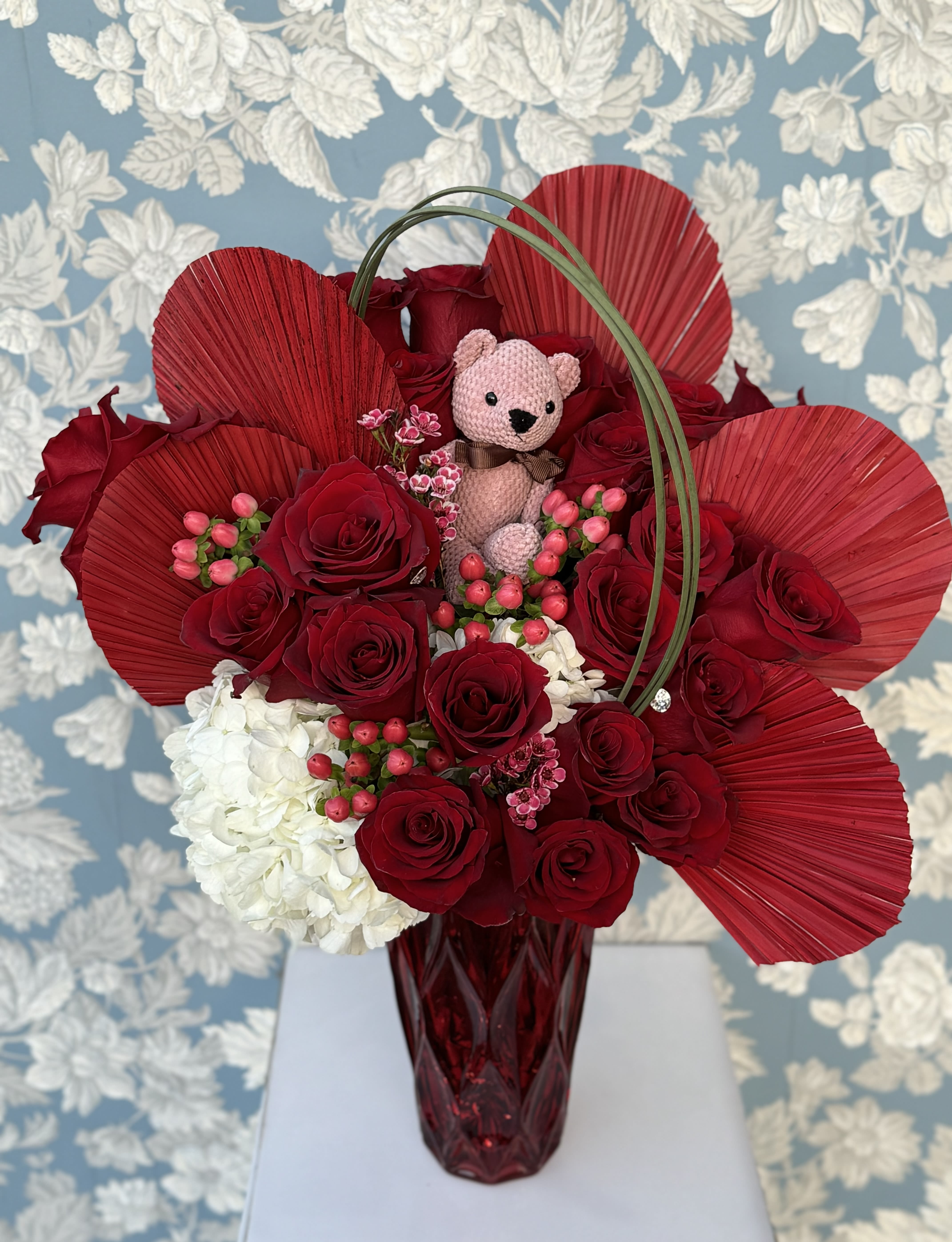 Love It - 2 Dozen beautifully designed in a nice red vase with red dried palm leaves