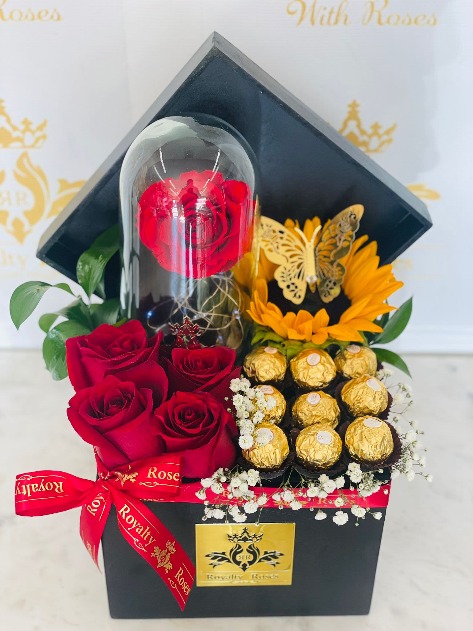 LIGHT UP ETERNAL ROSE WITH SUNFLOWER & ROSES FLORAL ARRANGEMENTS LIGHT UP ETERNAL ROSE WITH SUNFLOWER & ROSES FLORAL ARRANGEMENTS - Wooden box with red roses, sunflower, Eternal rose and chocolates.