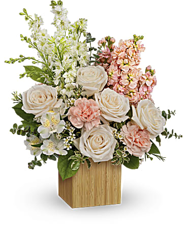 Teleflora's More Adored Bouquet Teleflora's More Adored Bouquet - Celebrate your adoration with this artistic bouquet of creamy blooms and lush greens in a stylish, eco-friendly bamboo cube! Crème roses, white larkspur, peach stock, white alstroemeria and white waxflower are arranged with variegated pittosporum, lemon leaf and spiral eucalyptus. Delivered in Teleflora's Small Bamboo Cube. Orientation: All-Around