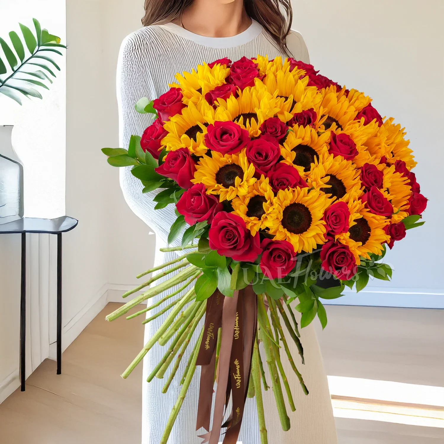 Striking Expression of Love Striking Expression of Love - This radiant bouquet of 20 sunflowers and 25 red roses, beautifully hand-tied with elegant brown ribbons, is a striking expression of love, admiration, and warmth. Perfect for anniversaries, romantic gestures, or special celebrations, this arrangement combines bold vibrancy with timeless elegance.