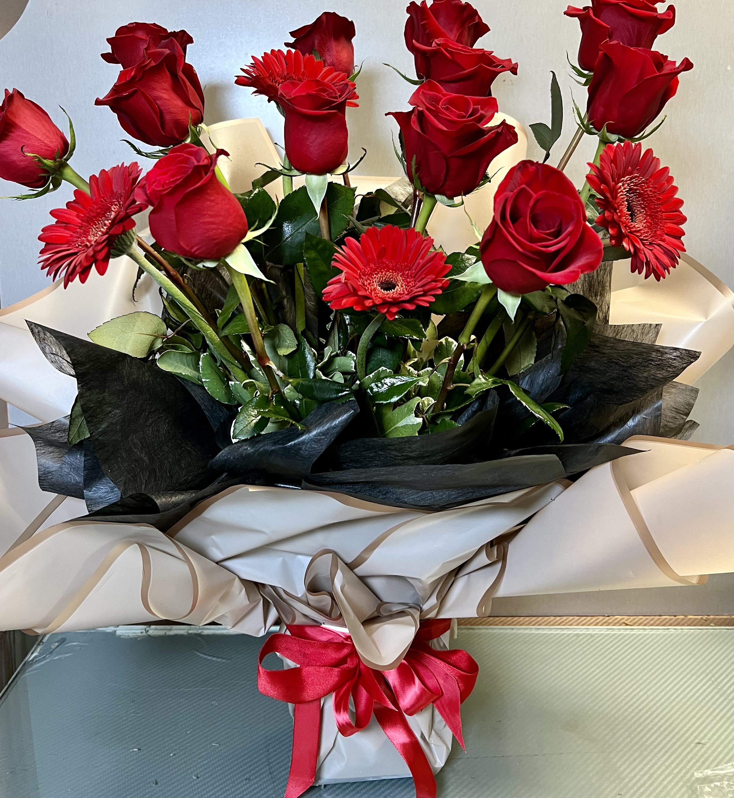 Rubi Flames - Red Roses and Gerbera Daisies AS SIMILAR AS POSSIBLE Substitution based on season, flowers availability or any unforeseen or uncontrollable circumstances 
