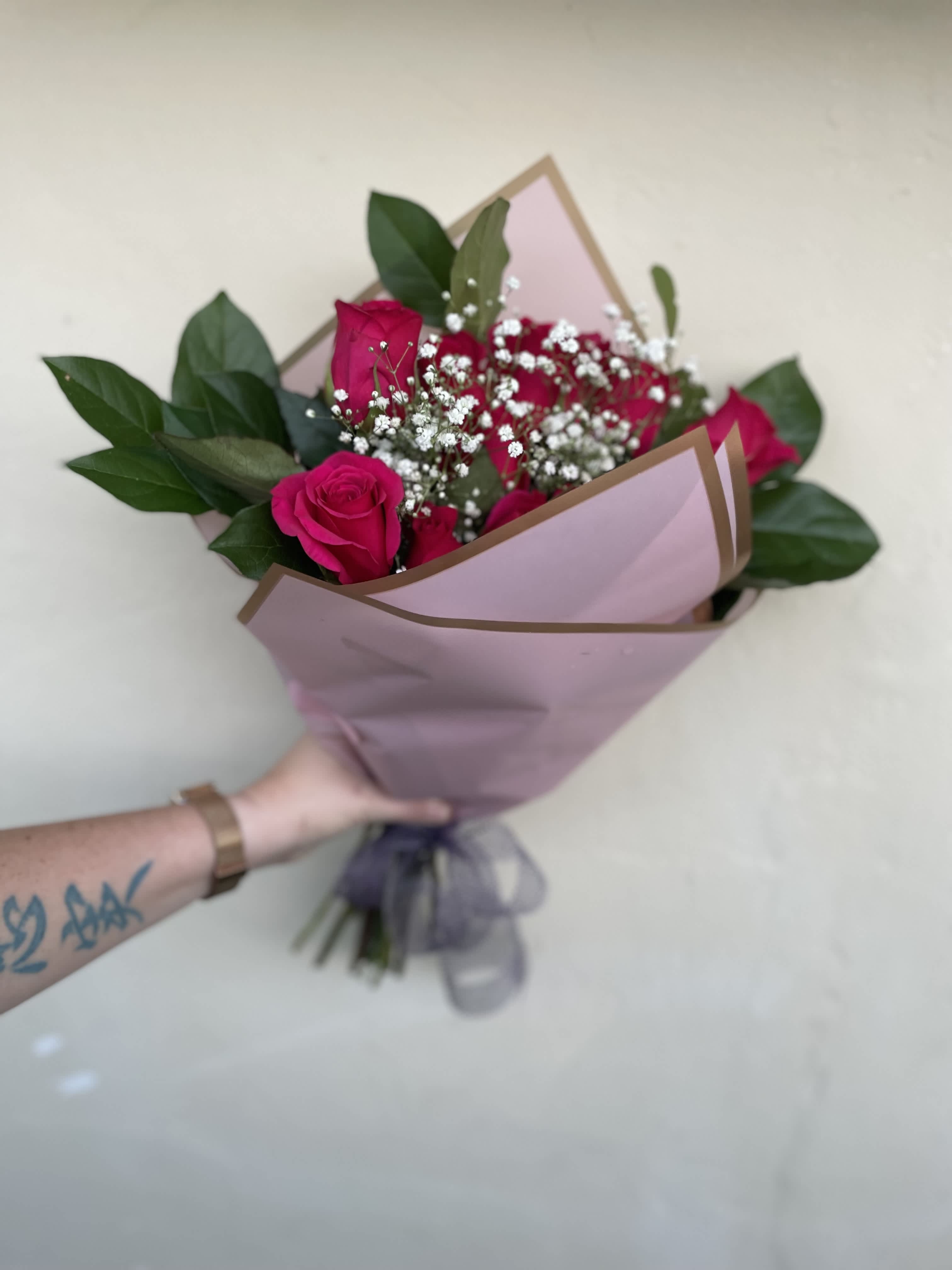 Hot pink dozen wrapped - 1 dozen elegant hot pink roses wrapped in premium bouquet paper tied with a silk bow