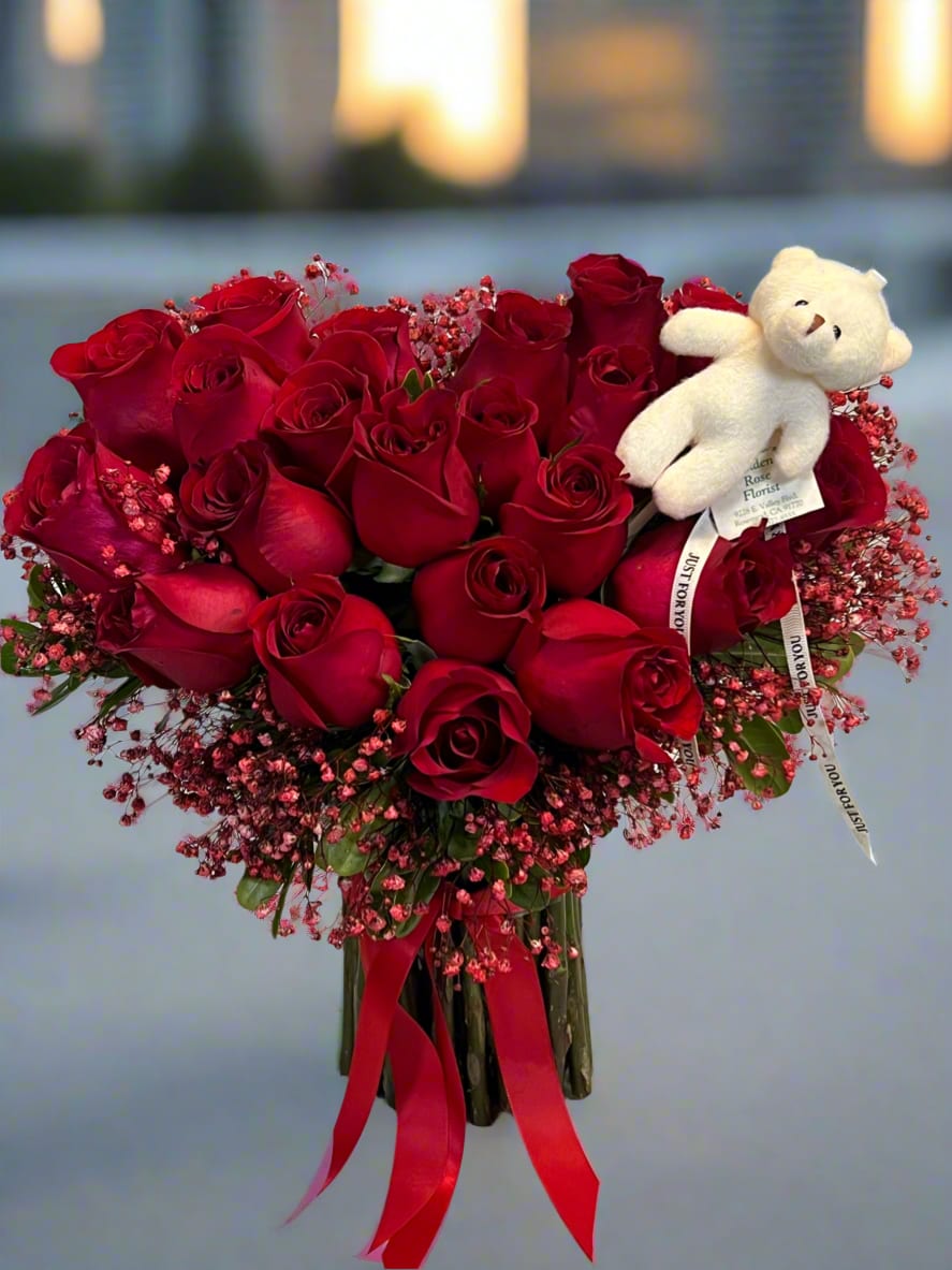 Forever Yours Arrangement - A stunning bouquet of radiant red roses arranged elegantly accented with baby’s breath for a touch of delicacy. Tied with a bold red ribbon and featuring an adorable plush bear, this arrangement symbolizes timeless love and affection. Perfect for Valentine’s Day, anniversaries, or any moment you want to express your deepest feelings with grace and charm.  Disclaimer:   In the event of seasonal availability, unforeseen factors, or lack of stock, some flowers or containers may be substituted with similar items of equal or higher quality. We will ensure the design, style, and color palette remain as close as possible to the original. Thank you for your understanding.