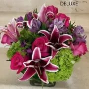 My Love Deluxe - Hot Pink roses with stargazer Lilies accented with Hydrangeas. Arranged in a glass cube. The quantity of flowers increase with Deluxe and more for Premium. 