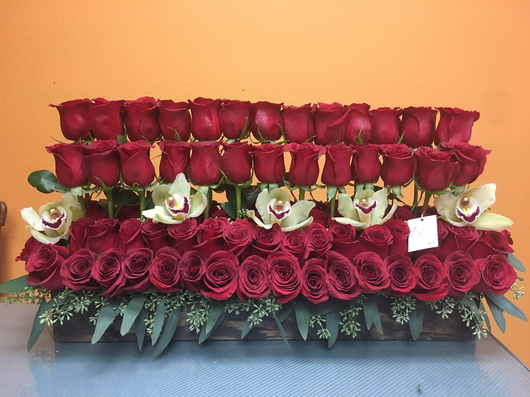 BXR02232 BXR02232 - 8 Dz Premium Roses Approx. Cymbidium Orchids AS SIMILAR AS POSSIBLE Substitution based on season, flowers availability or any unforeseen or uncontrollable circumstances