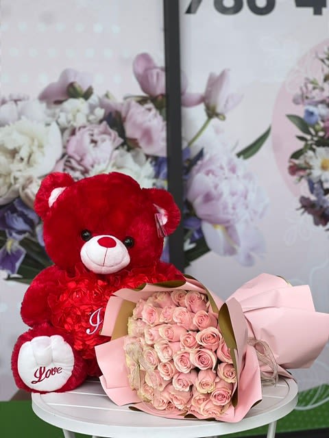 "I Love You" Teddy Bear with Roses - Red Edition "I Love You" Teddy Bear with Roses - Red Edition - Surprise your special someone with the perfect gift! A bouquet of beautiful roses, accompanied by a soft red teddy bear, is sure to melt their heart. It's the perfect way to show just how much you care! Standard includes 12 roses Deluxe includes 24 roses Premium includes 36 roses