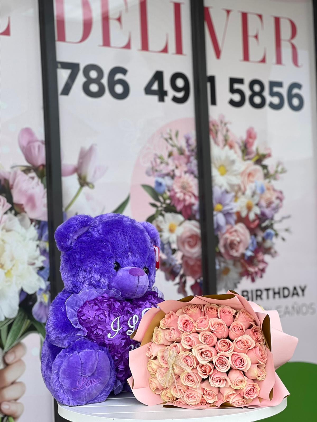"I Love You" Teddy Bear with Roses - Purple Edition "I Love You" Teddy Bear with Roses - Purple Edition - Surprise your special someone with the perfect gift! A bouquet of beautiful roses, accompanied by a soft purple teddy bear, is sure to melt their heart. It's the perfect way to show just how much you care! Standard includes 12 roses Deluxe includes 24 roses Premium includes 36 roses