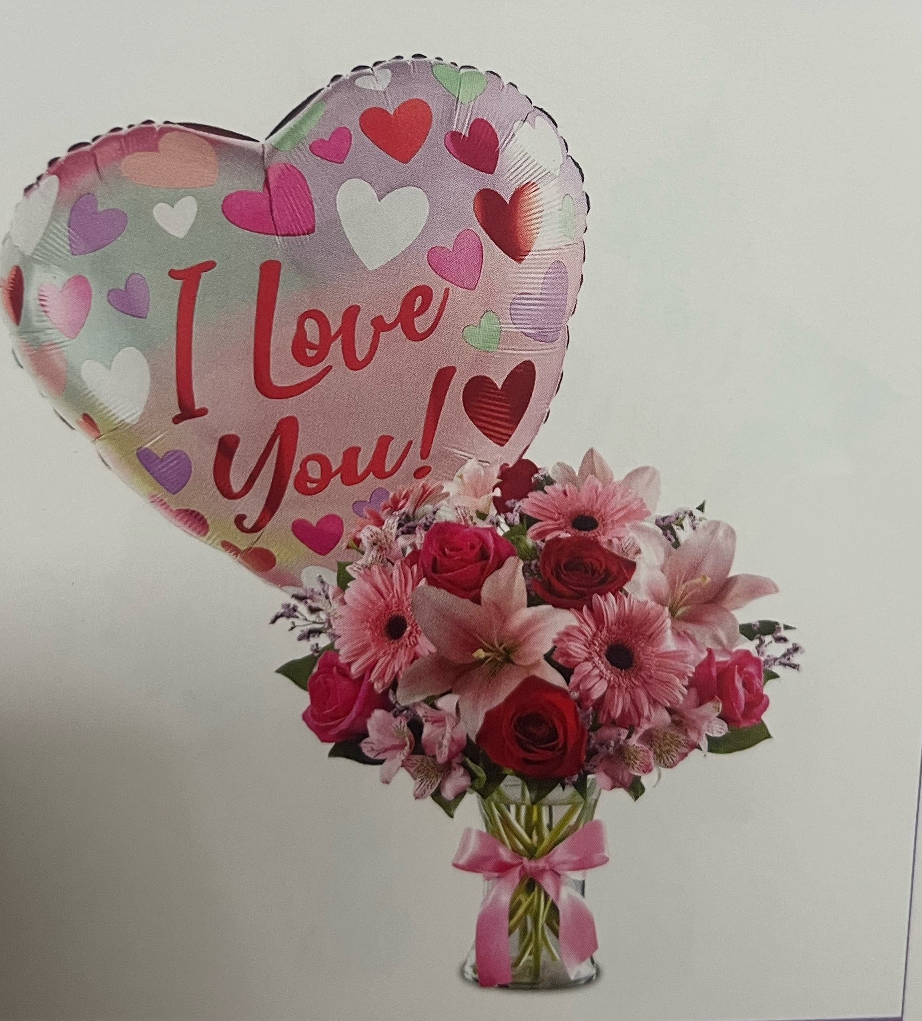 Fields and romance with ballon Fields and romance with ballon - All around arrangement with Rosa’s red Rosa’s pink lily gerbera dayse astromerias and greens