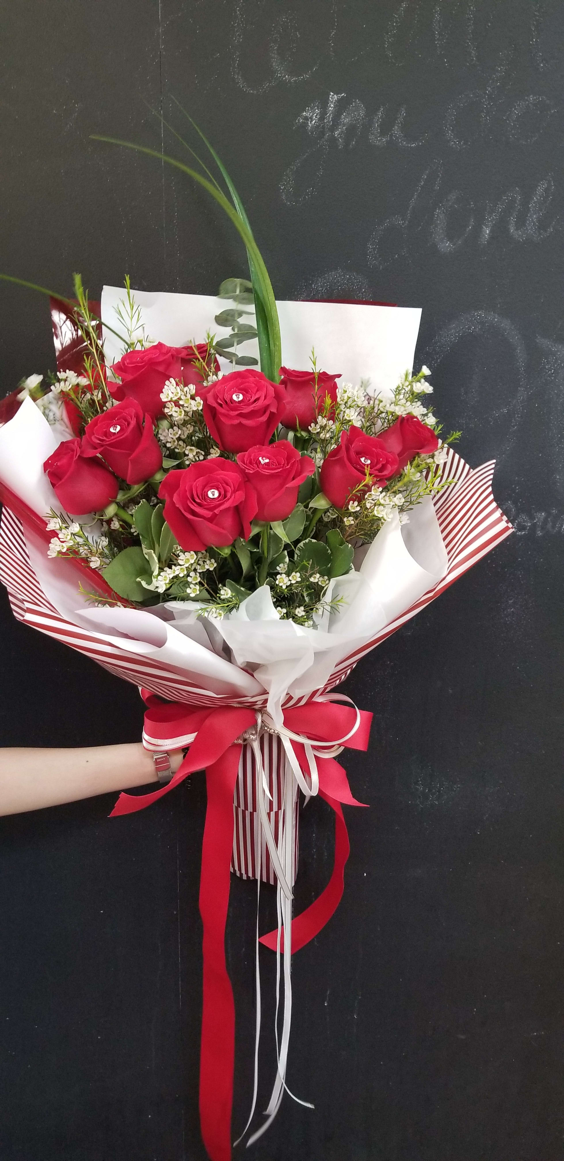 Love's Divine Bouquet  - It's like receiving an armful of Love. They speak, beautifully glowing bouquet of lush imported red roses in fancy imported wrapping materials and tied with satin ribbon.Wrapping material can be different by availability.