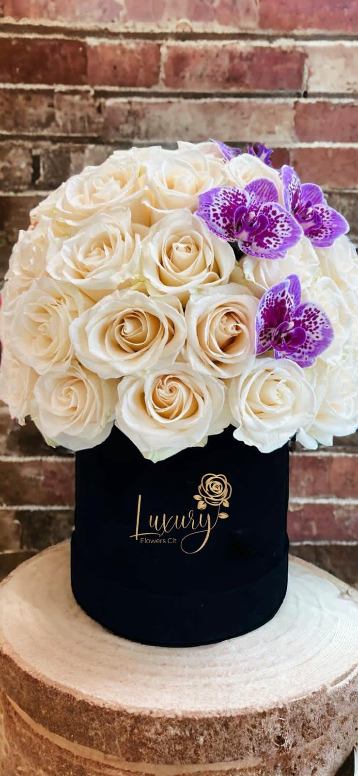 Friendship Box - This box delivers all the beauty together in one arrangement. Topped with beautiful cream/white roses with an elegant orchid. Color Box: White or Black (subject to inventory availability) Place your Order Online Monday to Saturday before 1:00 p.m. (E.T.) for same-day delivery.  “Orders received after hours will be delivered the next business day”. Check our coverage area. Occasionally, substitutions of flowers and/or containers happen due to weather, seasonality, and market conditions which may affect availability. If this is the case with the gift you’ve selected, we will ensure that the style, theme, and color scheme of your arrangement are preserved and will only substitute items of equal value or higher value.  CARE INSTRUCTIONS Gently mist the arrangement with natural water every other day. Do not spray any cleaning product on the flower arrangement. Do not place heavy objects directly on the flower arrangement. Keep them out of direct sunlight and extreme heat. 