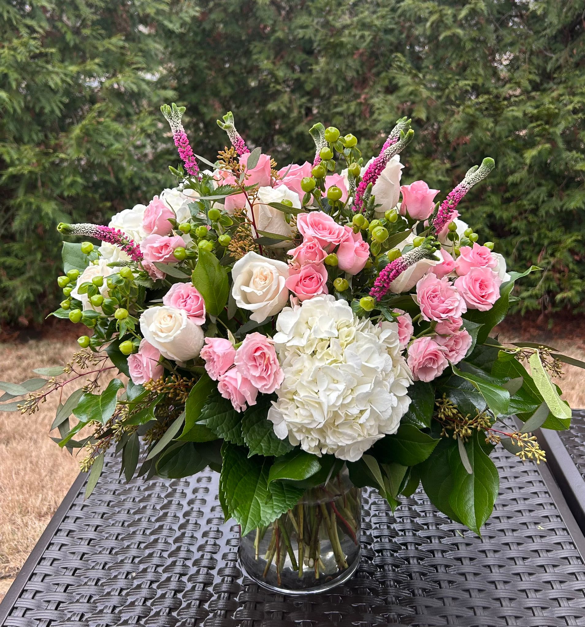 Raquel Bouquet - This arrangement a true symbol of luxury. Bloom Details: White Roses, White Hydrangeas, Light Pink Spray Roses, Pink Veronicas Clear Glass All Occasion Place your Order Online Monday to Saturday before 1:00 p.m. (E.T.) for same-day delivery. “Orders received after hours will be delivered the next business day”. Check our coverage area. Occasionally, substitutions of flowers and/or containers happen due to weather, seasonality, and market conditions which may affect availability. If this is the case with the gift you’ve selected, we will ensure that the style, theme, and color scheme of your arrangement are preserved and will only substitute items of equal value or higher value.  CARE INSTRUCTIONS Keep the flower arrangement hydrated with natural water and change the water every two days. Do not spray any cleaning product on the flower arrangement. Do not place heavy objects directly on the flower arrangement. Keep flower arrangements out of direct sunlight and extreme heat.