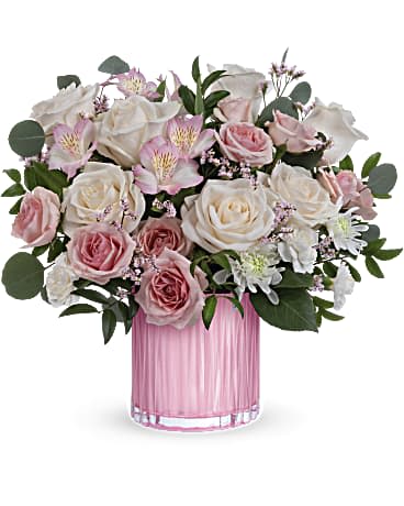 Posh Pink Bouquet - Teleflora's Posh Pink Bouquet has creamy roses and delicate pink blooms which are the perfect surprise, especially when they're arranged in this sculpted, pearlescent glass vase. Crème roses, pink spray roses, light pink alstroemeria, miniature white carnations, white cushion spray chrysanthemums and pink limonium are arranged with silver dollar eucalyptus and huckleberry. This gorgeous arrangement is delivered in Teleflora's Rosy Pink vase. Orientation: All-Around