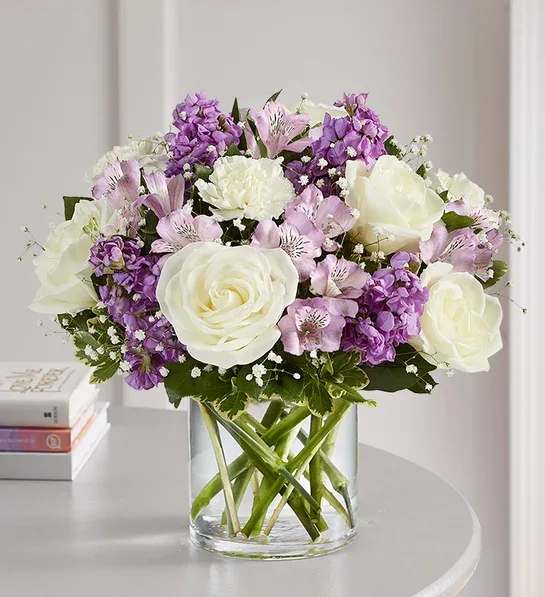 Lovely Lavender Medley - Lovely memories are made with thoughtful gifts for the ones we care about. Our charming lavender flower bouquet is loosely gathered with a medley of lavender &amp; white blooms. Hand-designed inside a clear cylinder vase with cascading greenery all around, it’s a wonderful way to express the sentiments you have inside your heart