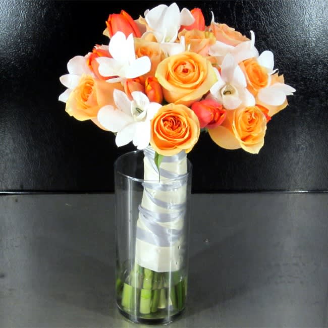 Roses, Tulips &amp; Orchids Bridal - This Bridal Bouquet features Ecuadorian Roses, Holland Tulips and Dendrobium Orchids. All of these blooms are gathered in a peach, orange and white theme but can be customized to your color preference.  Deluxe package includes Bridal and Toss Bouquet  All of our wedding work is custom and we can create any bouquet you've always wanted. Contact Us Online or Call Us at 619-237-8842 to discuss color options or to schedule a complimentary wedding consultation with one of our wedding designers, you will be glad you did!
