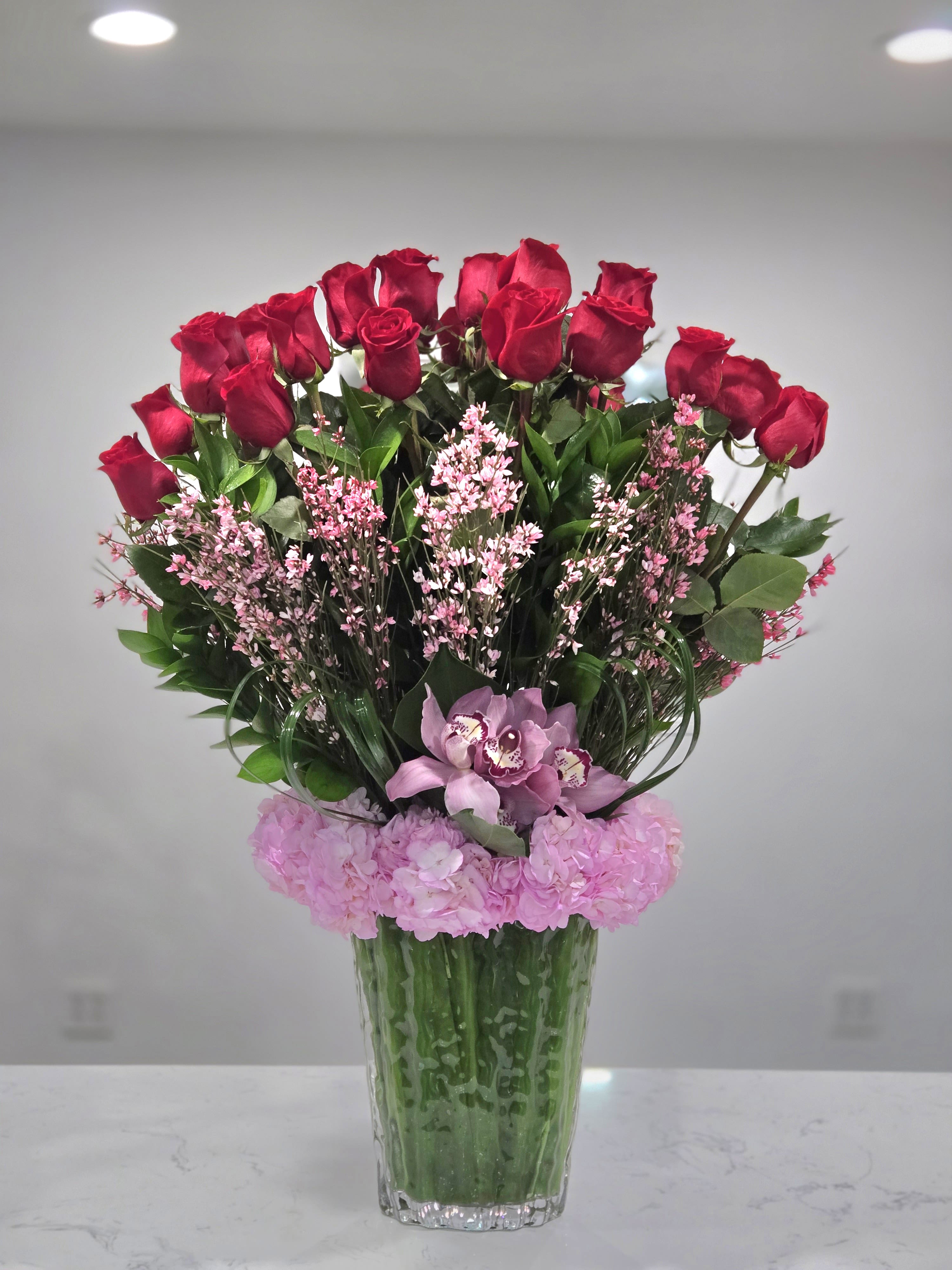 Eternal Love - A stunning Valentine’s arrangement of passionate red roses, soft pink blooms, and an elegant orchid, symbolizing romance and timeless beauty.