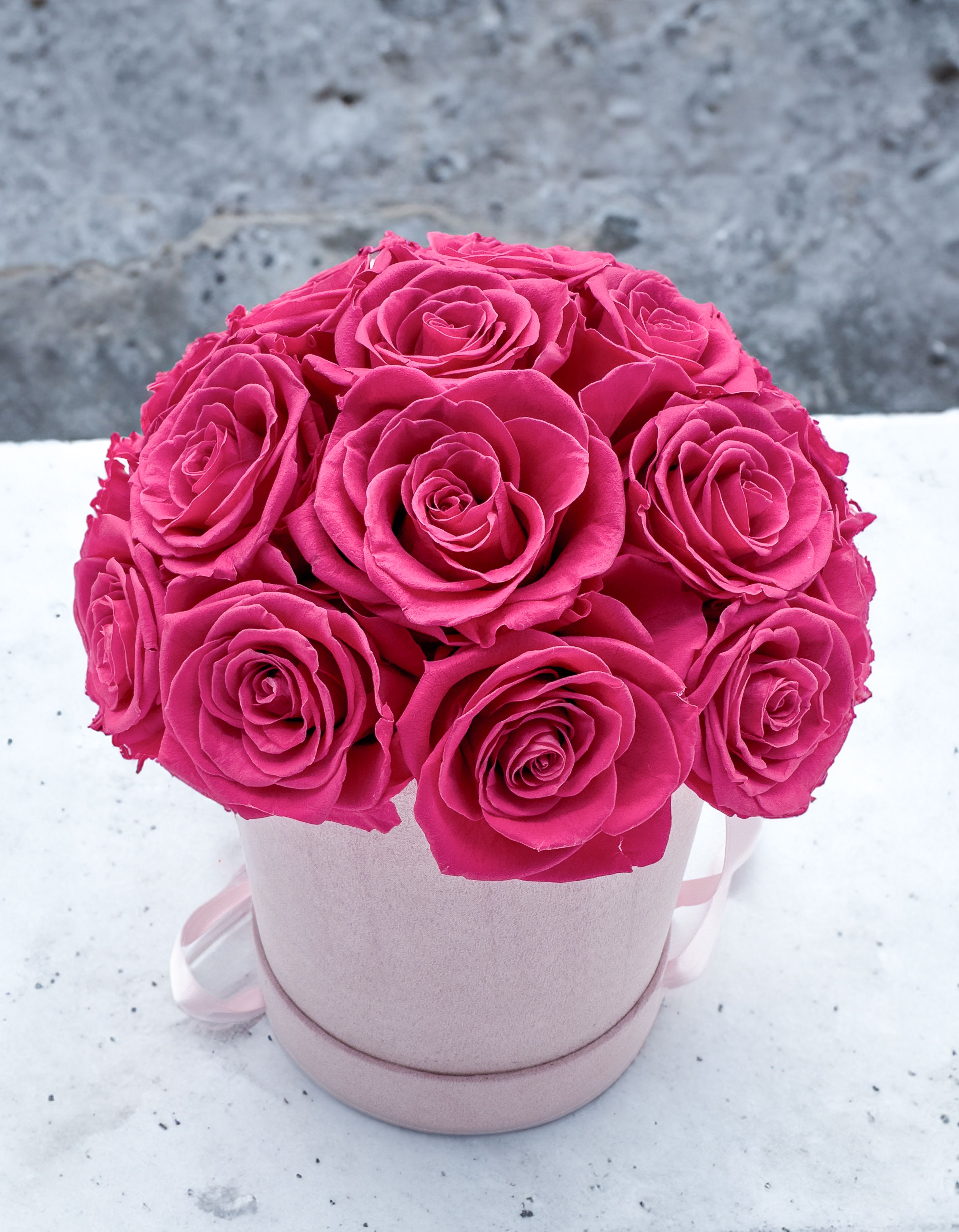 Forever Roses - Hot Pink - Elevate your space with our luxurious velvet cylinder box featuring real preserved roses. Available in arrangements of 16, 25, or 30 roses, each box showcases a dome-shaped arrangement of exquisite Ecuadorian preserved roses in your choice of red, white, light pink, or hot pink. Nestled within a plush velvet cylinder box, this stunning bouquet offers timeless beauty and elegance that lasts for years.  Our Forever Roses are the perfect way to show your love and appreciation - forever. Our exquisite roses are preserved to maintain their delicate beauty, for a sophisticated gift that will last a lifetime. Each rose dome is presented in an elegant velvet gift box, offering a truly special token of your affections.  Perfect for any occasion or as a striking decor piece, these preserved roses provide a maintenance-free alternative to fresh flowers, requiring no watering or upkeep. Each rose is carefully preserved to maintain its vibrant color and delicate texture, ensuring a long-lasting display that adds a touch of sophistication to any setting.  Standard : 16 Roses Deluxe: 25 Roses Premium: 30 Roses  Product Features:  • Luxurious Arrangement: Choose from 16, 25, or 30 preserved roses arranged in a dome shape. • Elegant Color Options: Available in red, white, light pink, or hot pink. • Velvet Cylinder Box: Packaged in a plush velvet box for a touch of luxury. • Maintenance-Free: No watering or wilting, offering enduring charm.  Box Dimensions:12x10x10 