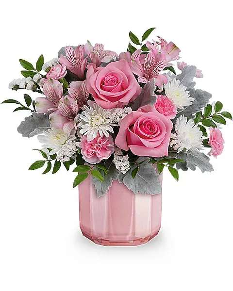 Sweet Blooms Bouquet - Delicate and charming, this pastel pink Valentine's Day bouquet is beautifully complemented by a sculpted pink glass vase featuring a shimmering pearlescent finish. This charming Valentine's Day bouquet features pink roses, pink alstroemeria, miniature pink carnations, and white cushion spray chrysanthemums, arranged with dusty miller and huckleberry. It's delivered in the Blushing Gem vase.  