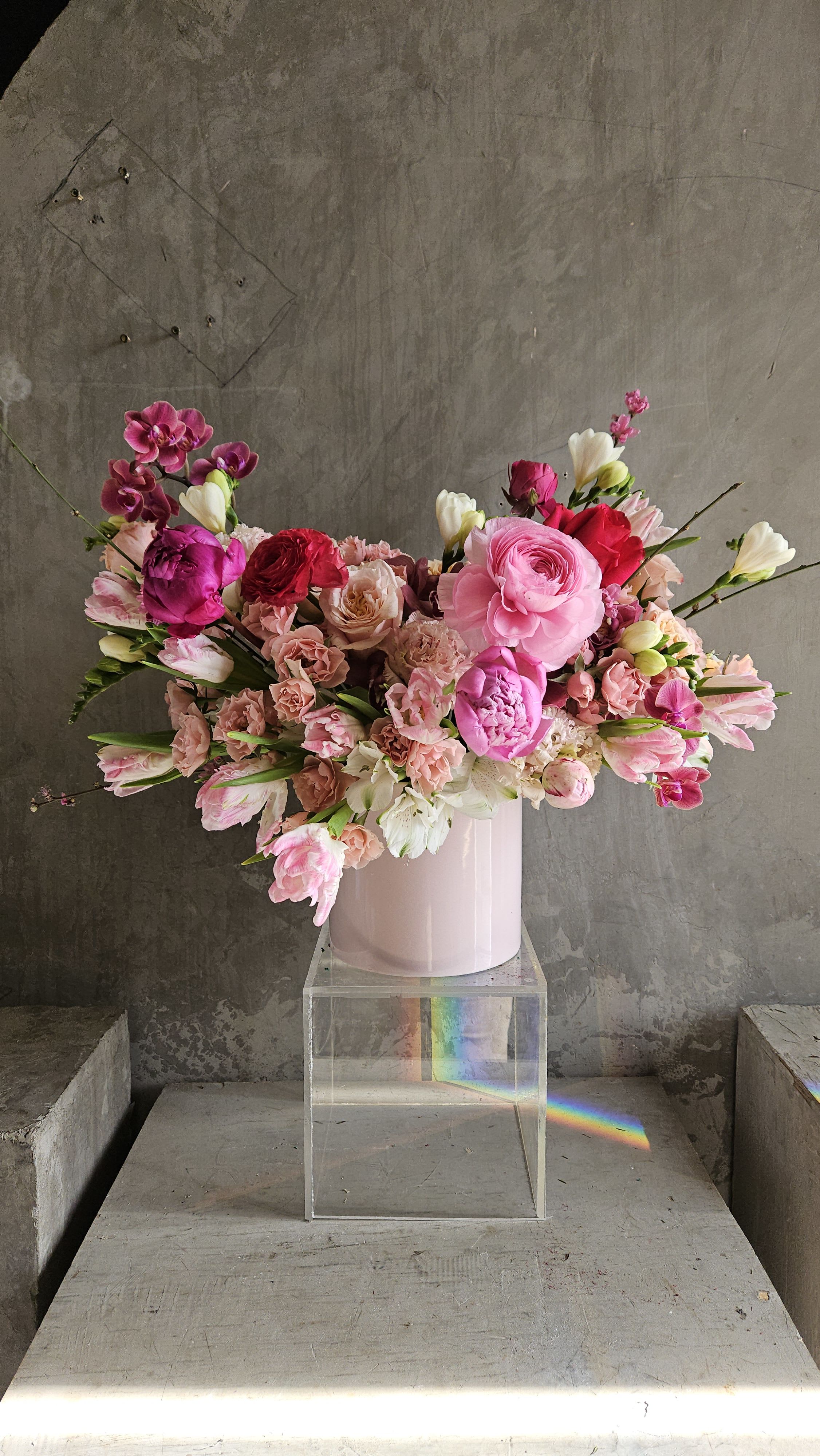 Crimson Elegance - Crimson Elegance in Pink is a stunning floral arrangement that blends rich crimson hues with soft pink tones, creating a captivating display of grace and sophistication. Lush blooms intertwine harmoniously, exuding romance and charm in every petal.