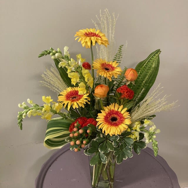 Thinking of you - This unique bright arrangement is the perfect way to let someone know you are thinking of them!  (Colors may vary)  Please Note: Each design is custom made and filled to value. We only use fresh product to ensure top quality so new orders are subject to substitutions. 