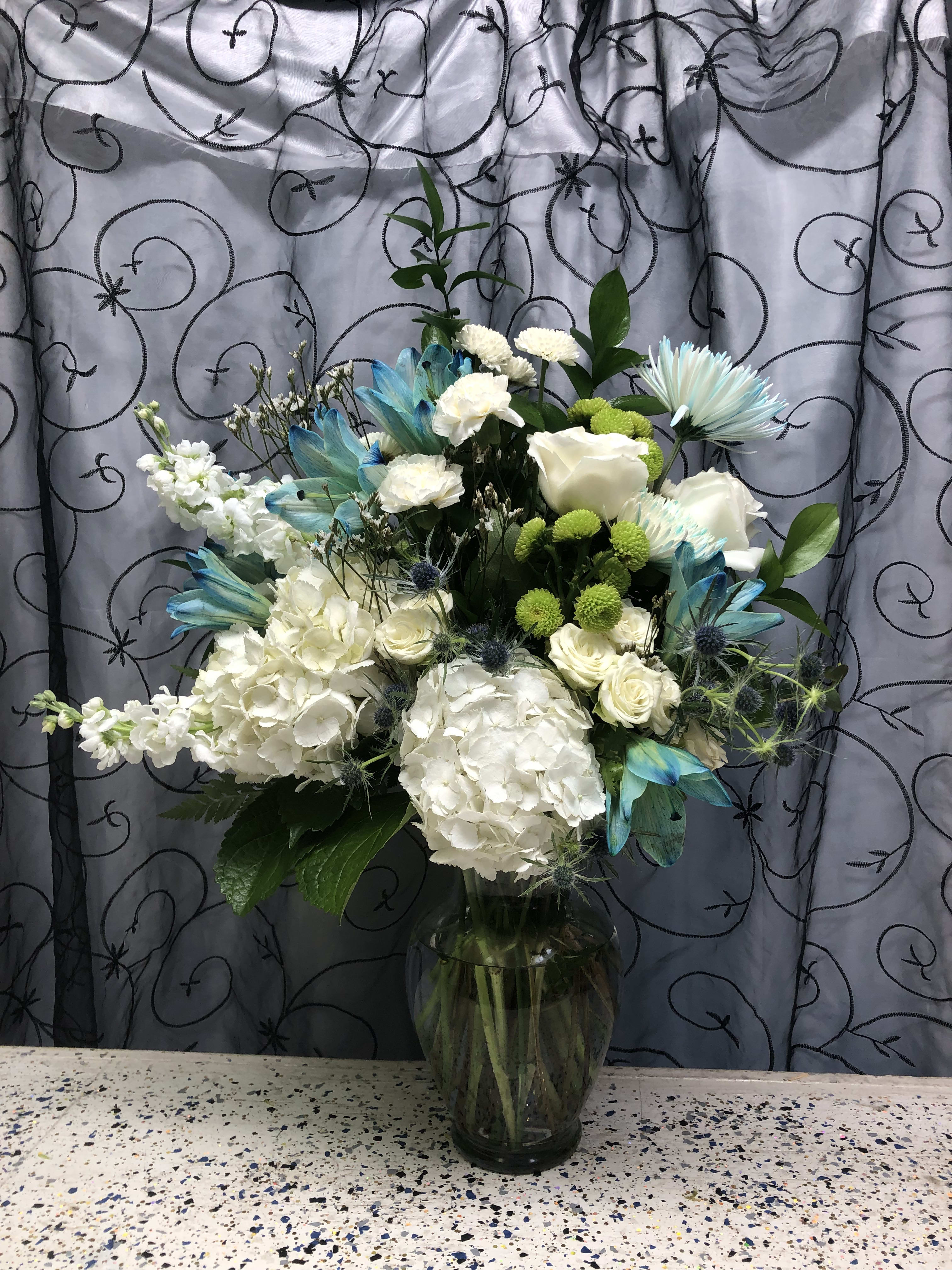 Blue nad white sympathy arrangement. Blue nad white sympathy arrangement. - Hydrangeas, stock, lilies, roses, spiders, green buttons and greenery.