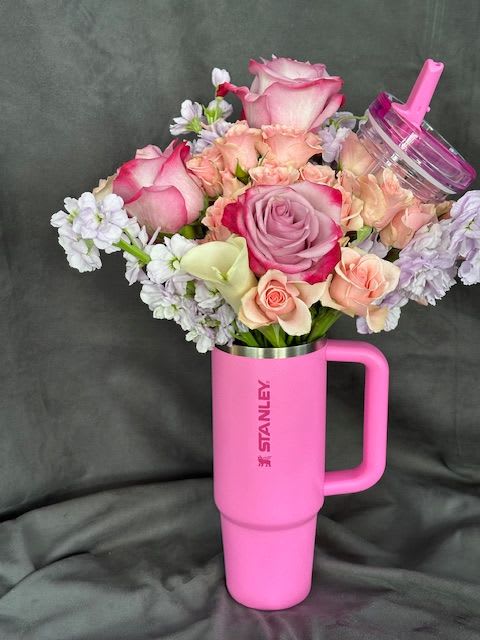 Flowers and Stanley - Stanley Cup filled with an arrangement of mixed florals.