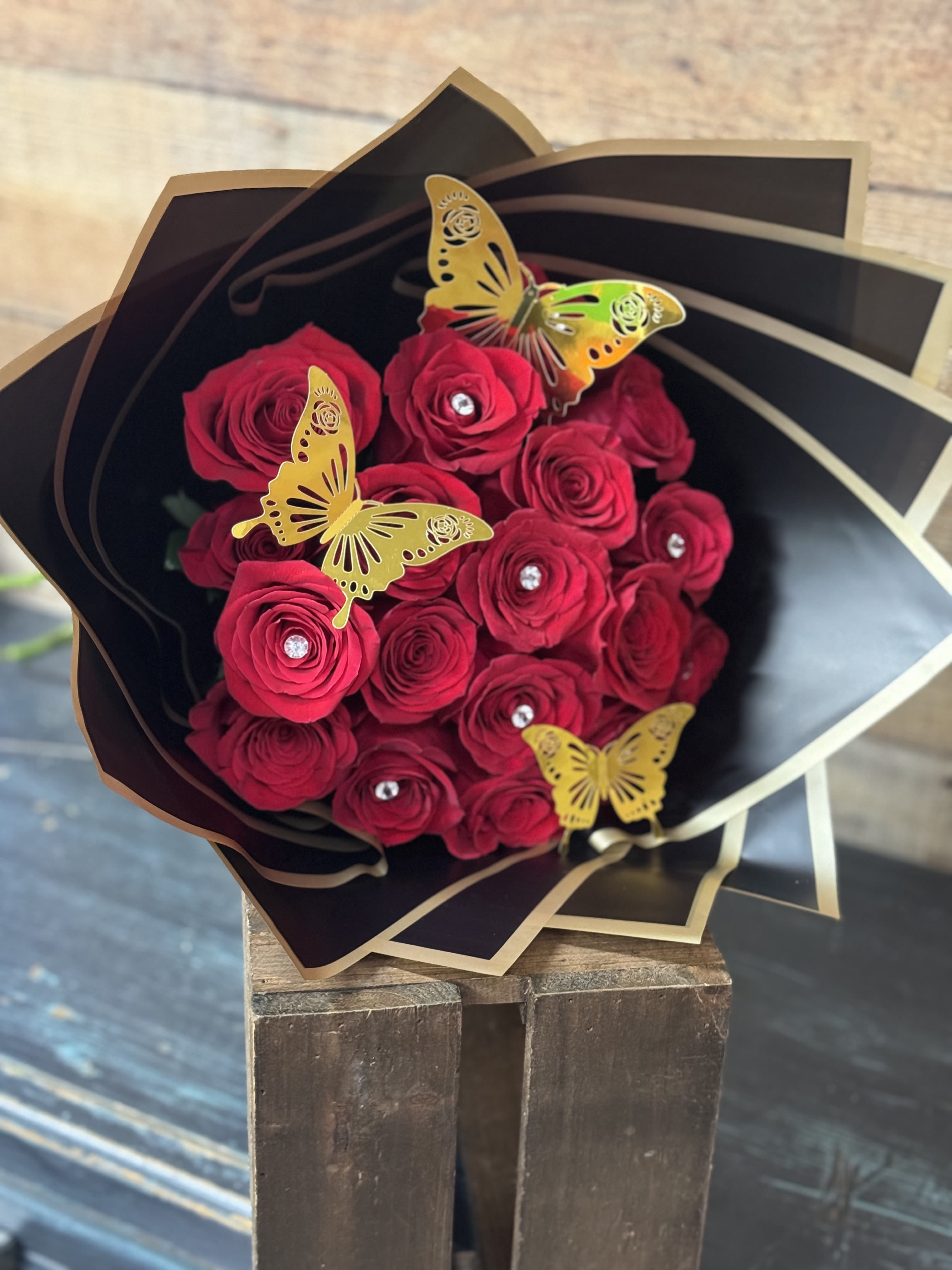 Ramo Buchon - A beautiful wrapped bouquet of 25, 50, or 100 roses. Please specify color of roses under special instructions. Photos- Red is Standard Arrangement               Pink is Deluxe Arrangement