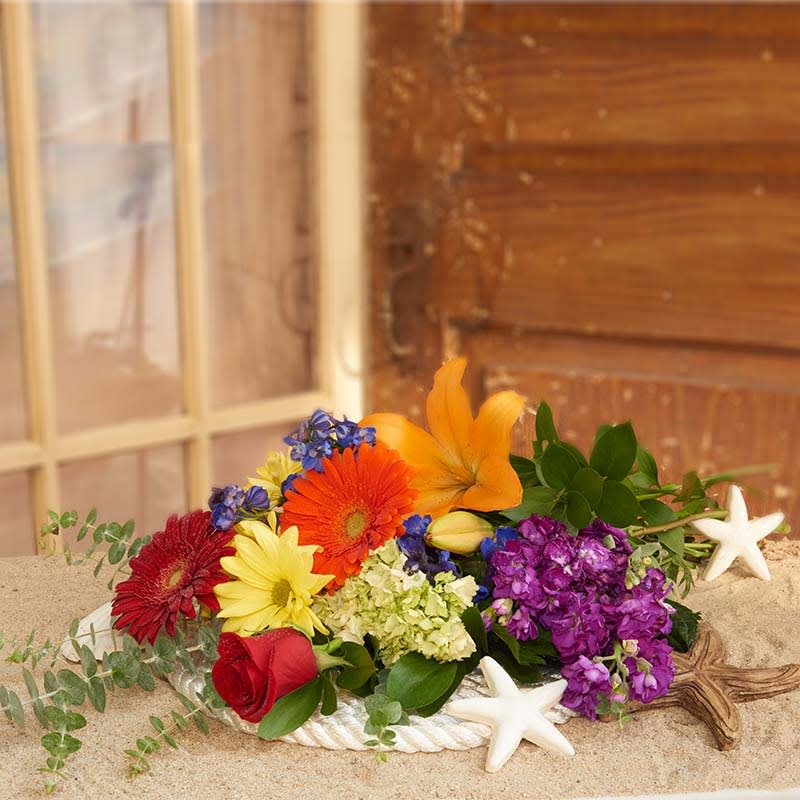 Ravishing Rainbow Bouquet Ravishing Rainbow Bouquet - Love the colors of the rainbow? Want to send the one you love a symbol of your love to them with our fresh selection of rainbow color blooms? We combine all the colors of the rainbow and hand tie them into a presentation bouquet. Flowers will vary from photo. We select a choice of a beautiful mixture of assorted flowers. (We wrap all stems in Arrive Alive- a product that will keep the stems hydrated for at least 12 hours) LGBT friendly. Props are not included.
