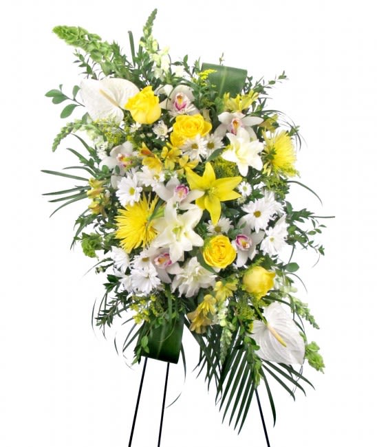 Soft Sunshine Sympathy Spray - When you don't know quite what to say to express your grief to those who have been left behind by a loved one, let flowers say the words for you. Our Soft Sunshine Sympathy Spray features a dazzling array of white and yellow flowers including premium Roses, Crystal Blanca Lilies, Cymbidium Orchids, White Anthurium, Alstroemeria, Snapdragons, Daisies, Chrysanthemums, Bells of Ireland, Solidago or similar seasonal favorites, sure to brighten spirits.  Appropriate for wakes, funerals, and memorial services, this Sympathy Spray measures approximately 25in (W) x 50in (H), for a total of approximately 80 inches (H) when displayed on the easel stand. Deluxe and Premium styles are larger and feature more premium blooms.  Please Note: This is a special order floral arrangement. Place your order online and allow at least 1-2 business days for order processing. Please give us a call at 619-237-8842 for same day delivery options. Some substitutions may be necessary due to seasonal availability of certain blooms used in this composition. We can assure you that your order will only be upgraded with same or higher value premium blooms if a substitution is unavoidable.