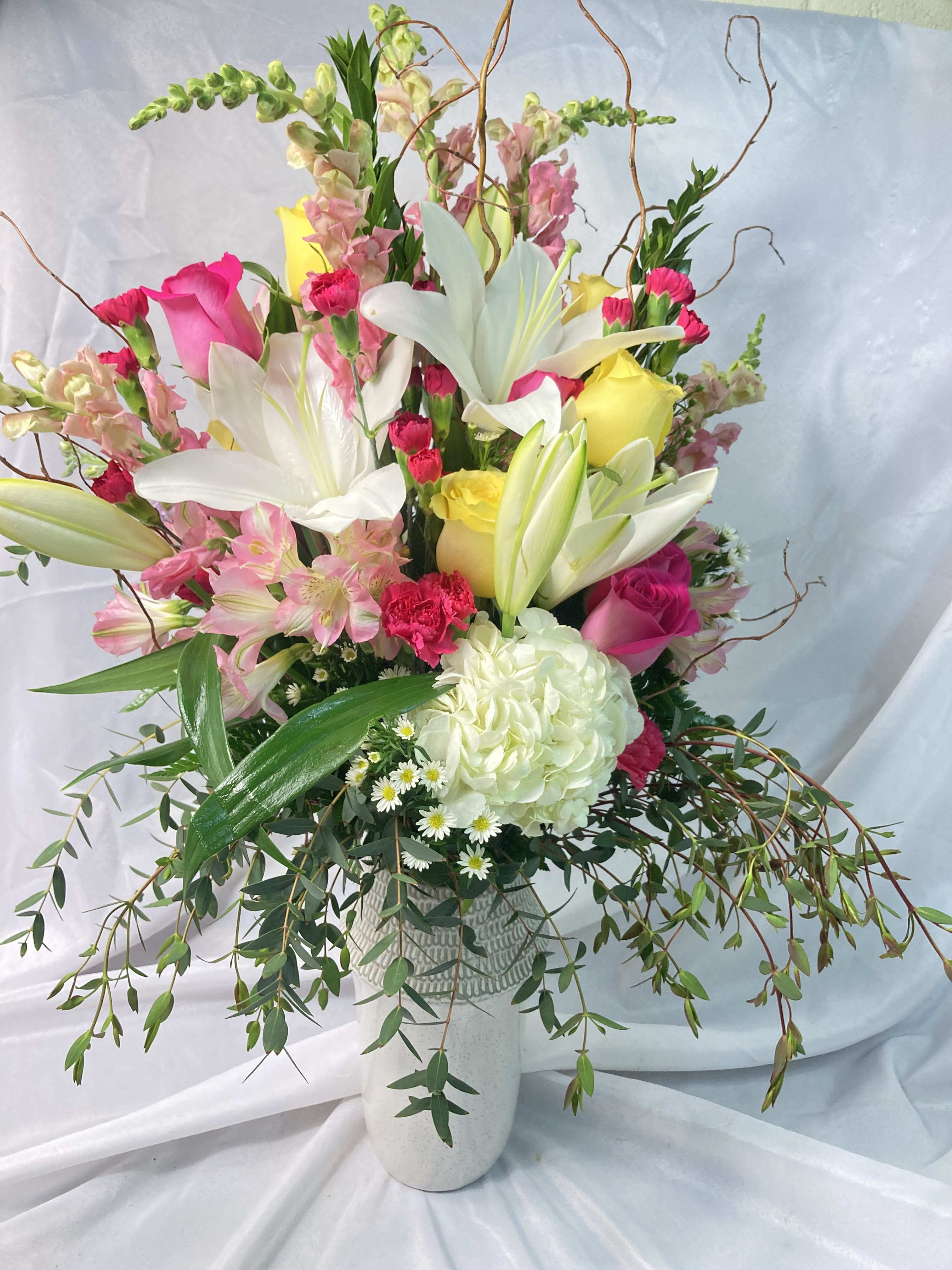 Flower Garden Bouquet - A large display of a whole garden of blooms! This fresh bouquet features large white    Casablanca Lilies, Hydrangeas and Roses with Curly Willow, Snapdragons, Alstroemeria and Chrysanthemums. All this in our ceramic, keepsake vase to send a huge wish to your loved one. 