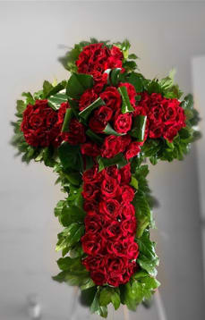 Sacred Red Rose Cross Funeral Tribute Sacred Red Rose Cross Funeral Tribute - A profound symbol of faith, love, and eternal remembrance, this Sacred Red Rose Cross is a stunning floral tribute to honor the memory of a loved one. Designed with lush, velvety red roses, accented by fresh greenery, this standing spray conveys deep devotion, respect, and heartfelt sympathy.