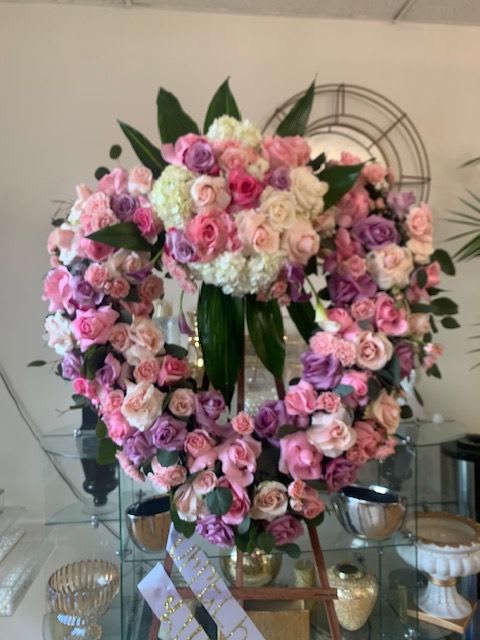 Graceful Pink & Purple Open Heart Funeral Tribute Graceful Pink & Purple Open Heart Funeral Tribute - Express love, admiration, and remembrance with this stunning open-heart floral arrangement, designed to honor the memory of a loved one. Featuring an elegant blend of soft pink, blush, and lavender roses, accented with white hydrangeas and lush greenery, this tribute symbolizes eternal love and a lasting bond.