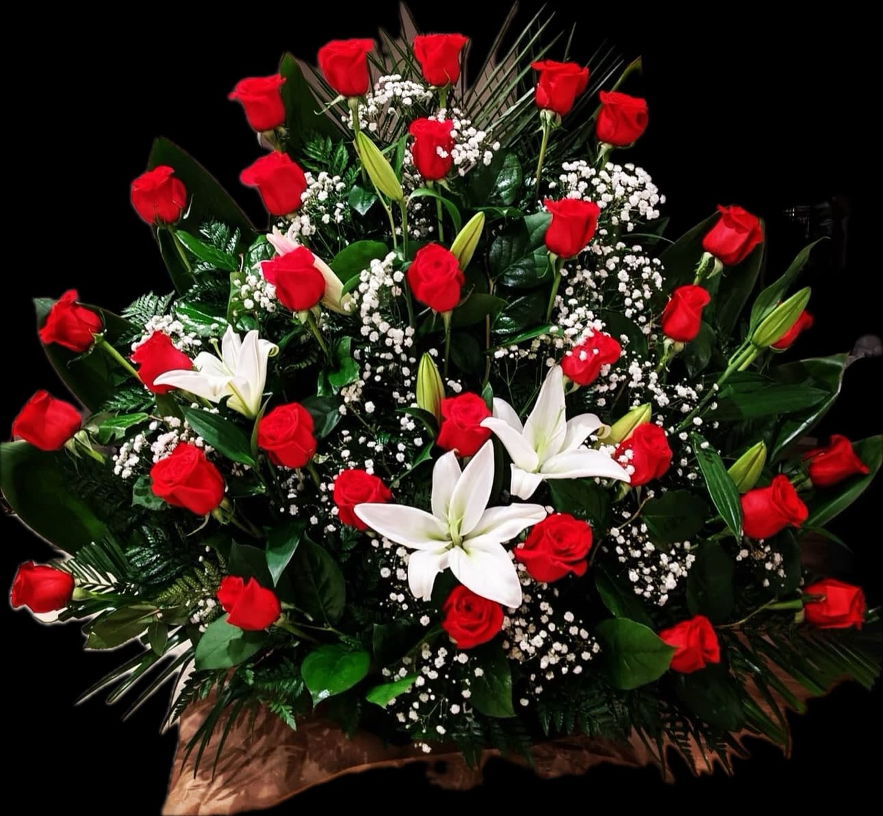 Elegance in Love - This beautiful arrangement is adorned with Ecuadorian long stem red roses along with White lilies and filler. 