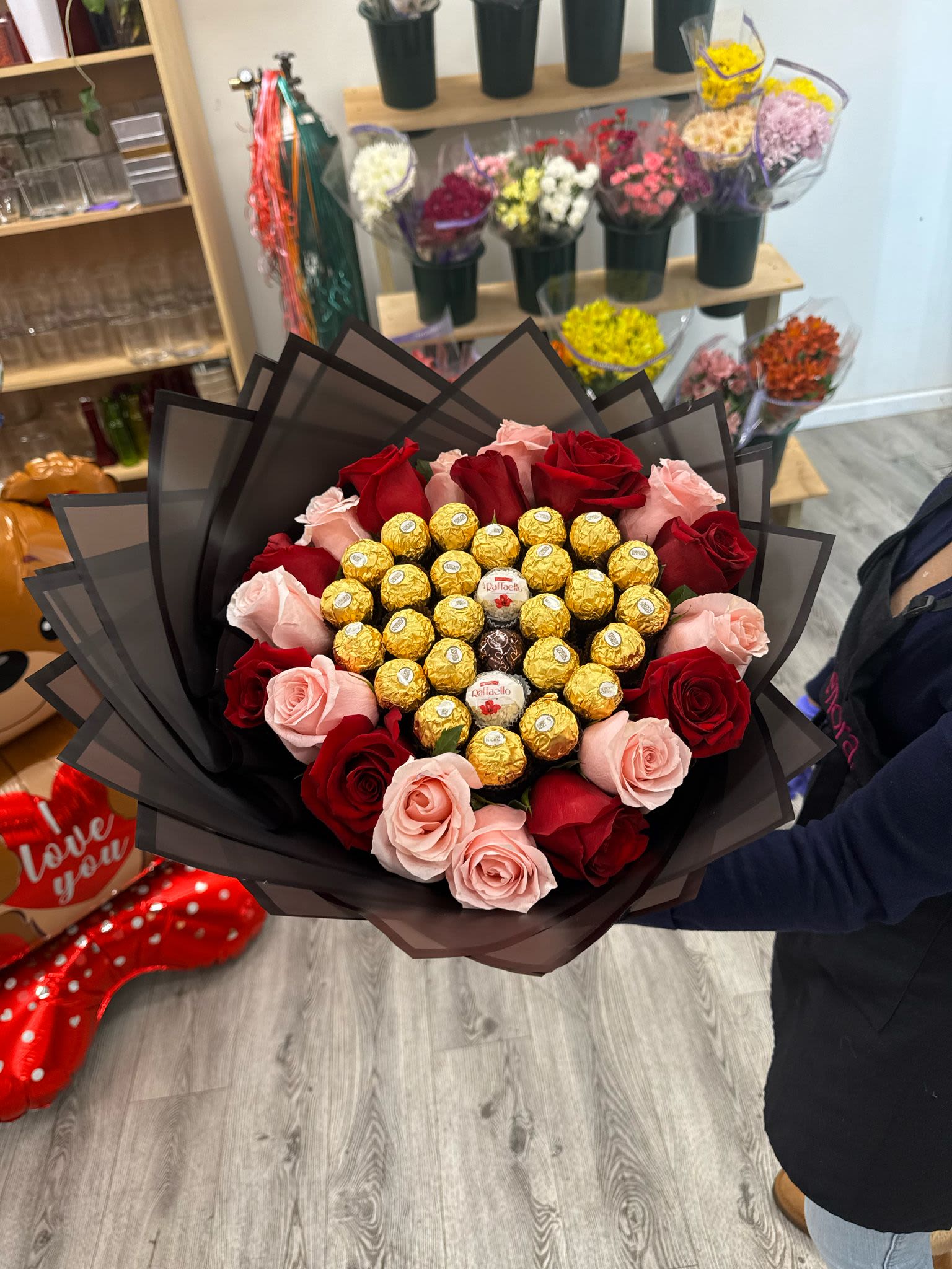 Heart shaped bouquet with red roses and light pink - Bouquet with Ferreros chocolates and mix roses , wrapped in floral paper