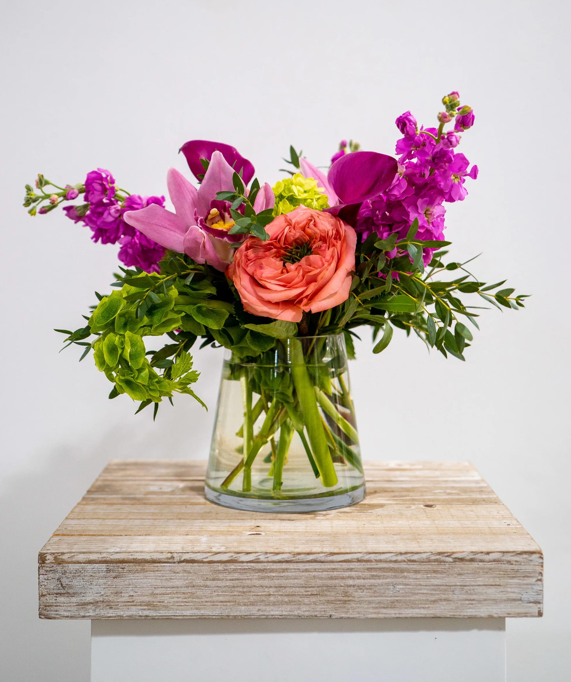 SERENE - A beautiful compact arrangement of garden roses, mini green hydrangea, stock, cymbidiums, calla lilies and eucalyptus. 