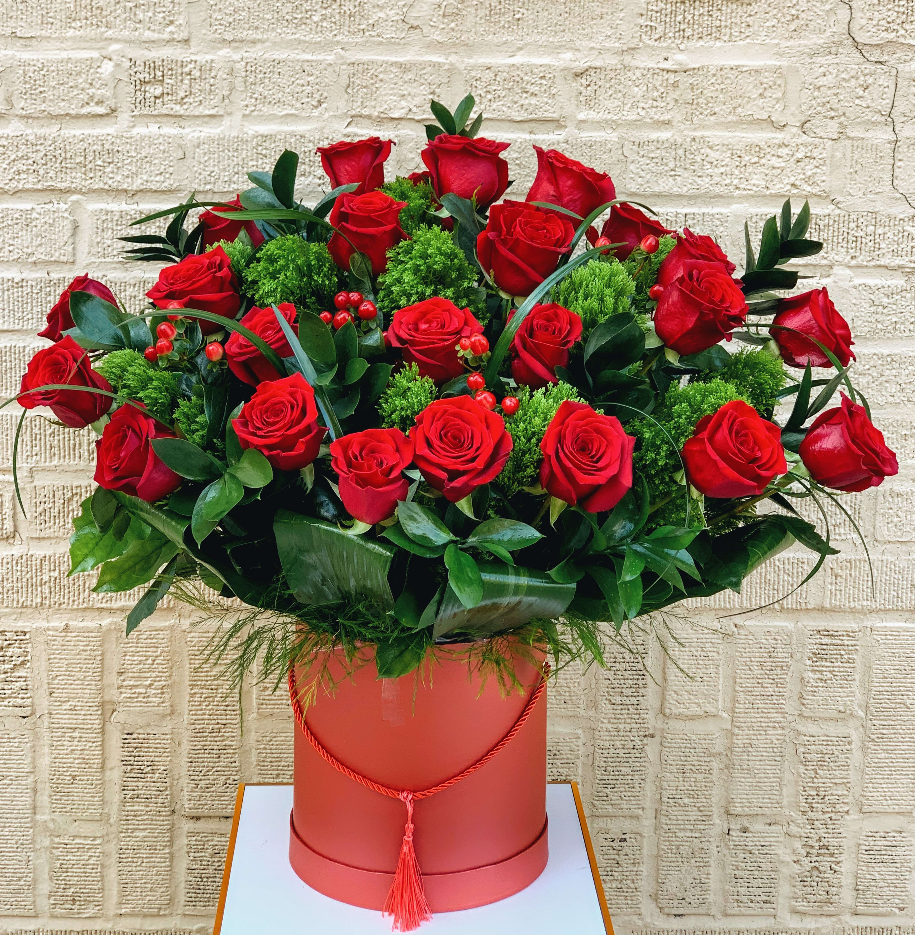 Aurora - Large and tall basket box with long  red roses in greenery and with red berries.