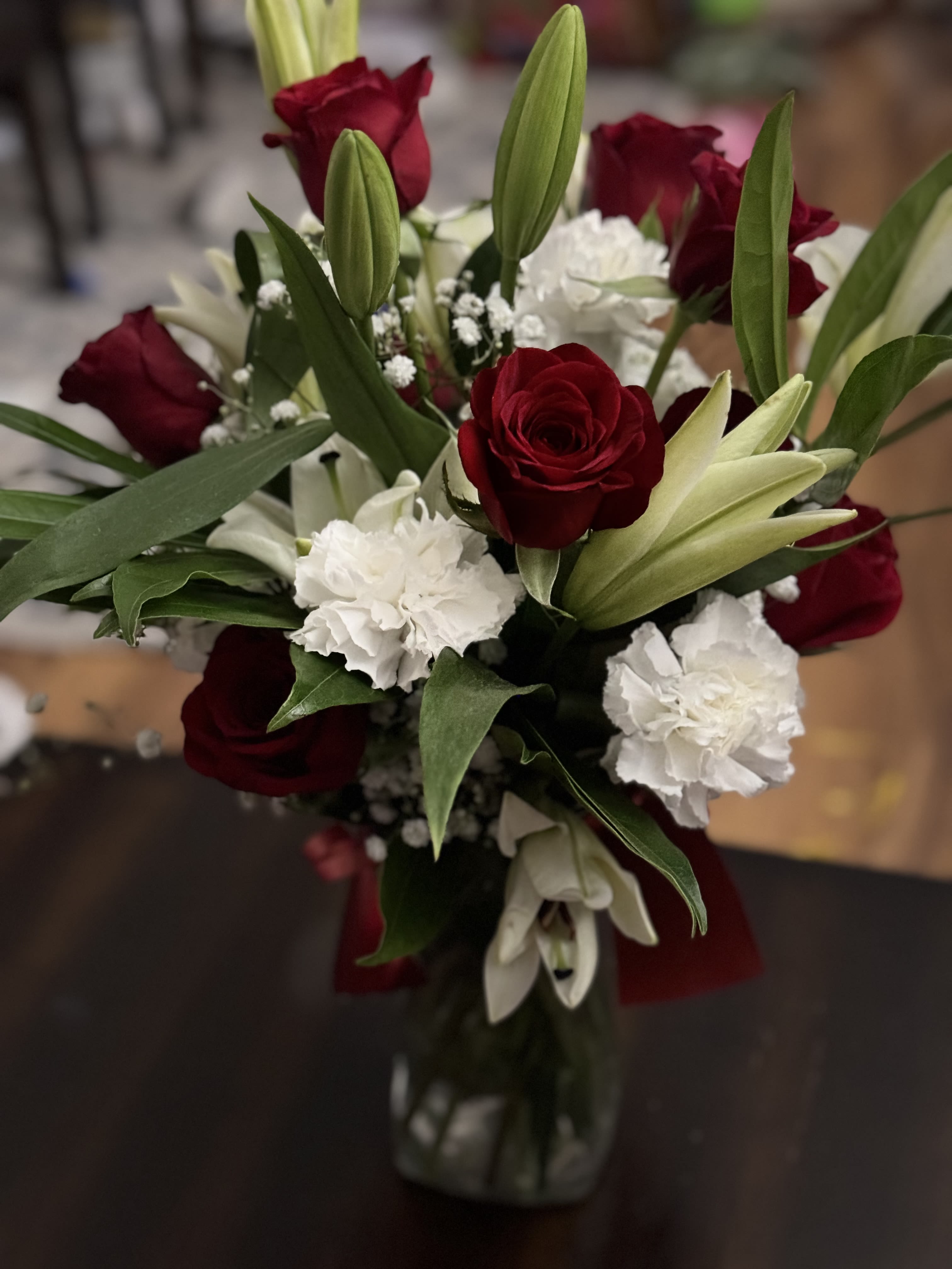 VISIONS OF LOVE by Misrak  - A vision of love! This luxe bouquet of fragrant white lilies and radiant red roses, hand-delivered in a ruby vase, is the perfect expression of your feelings.