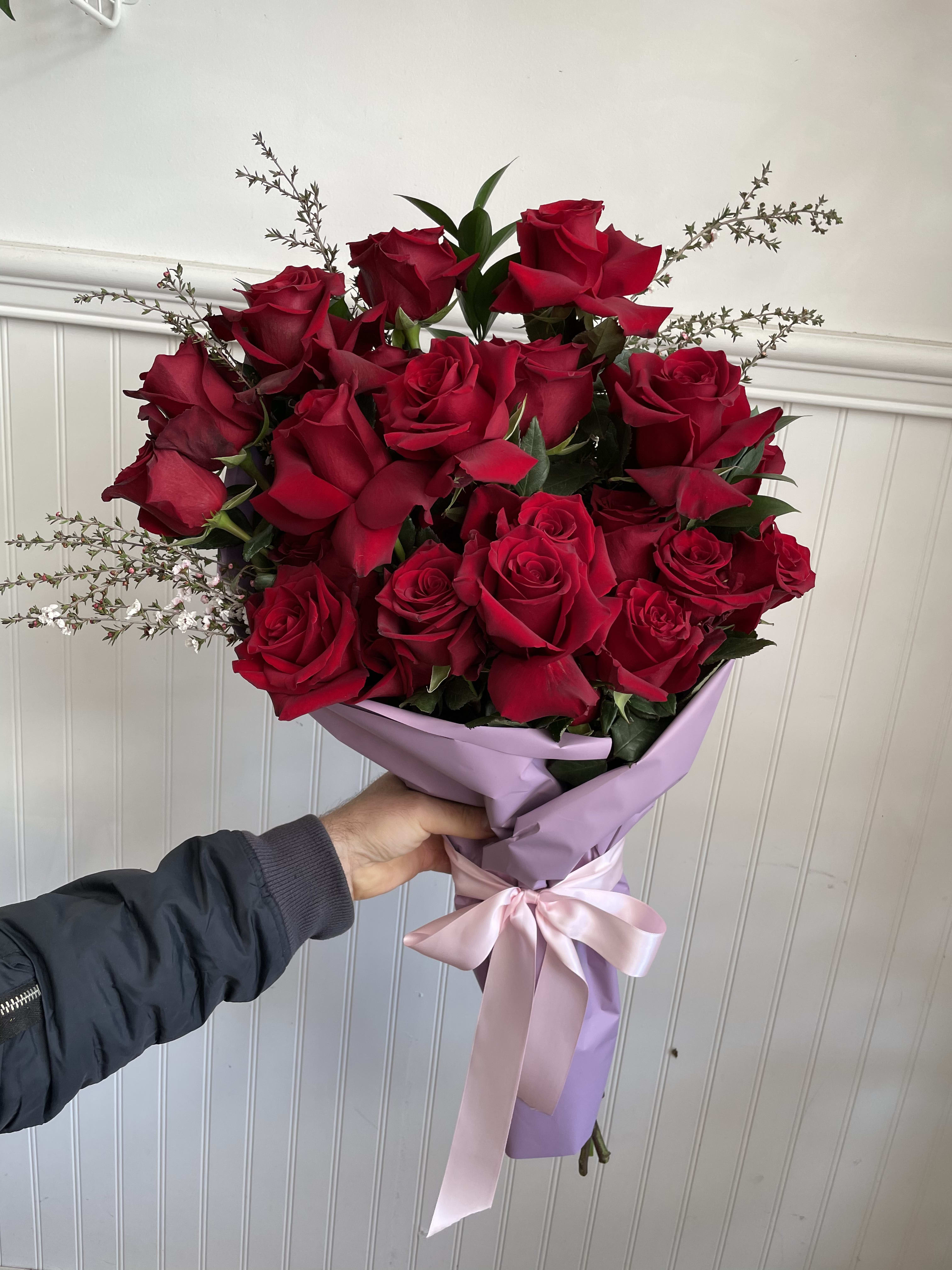 Bundle of 24 Bundle of 24 - 24 beautiful red roses wrapped in colorful paper and ties with ribbon