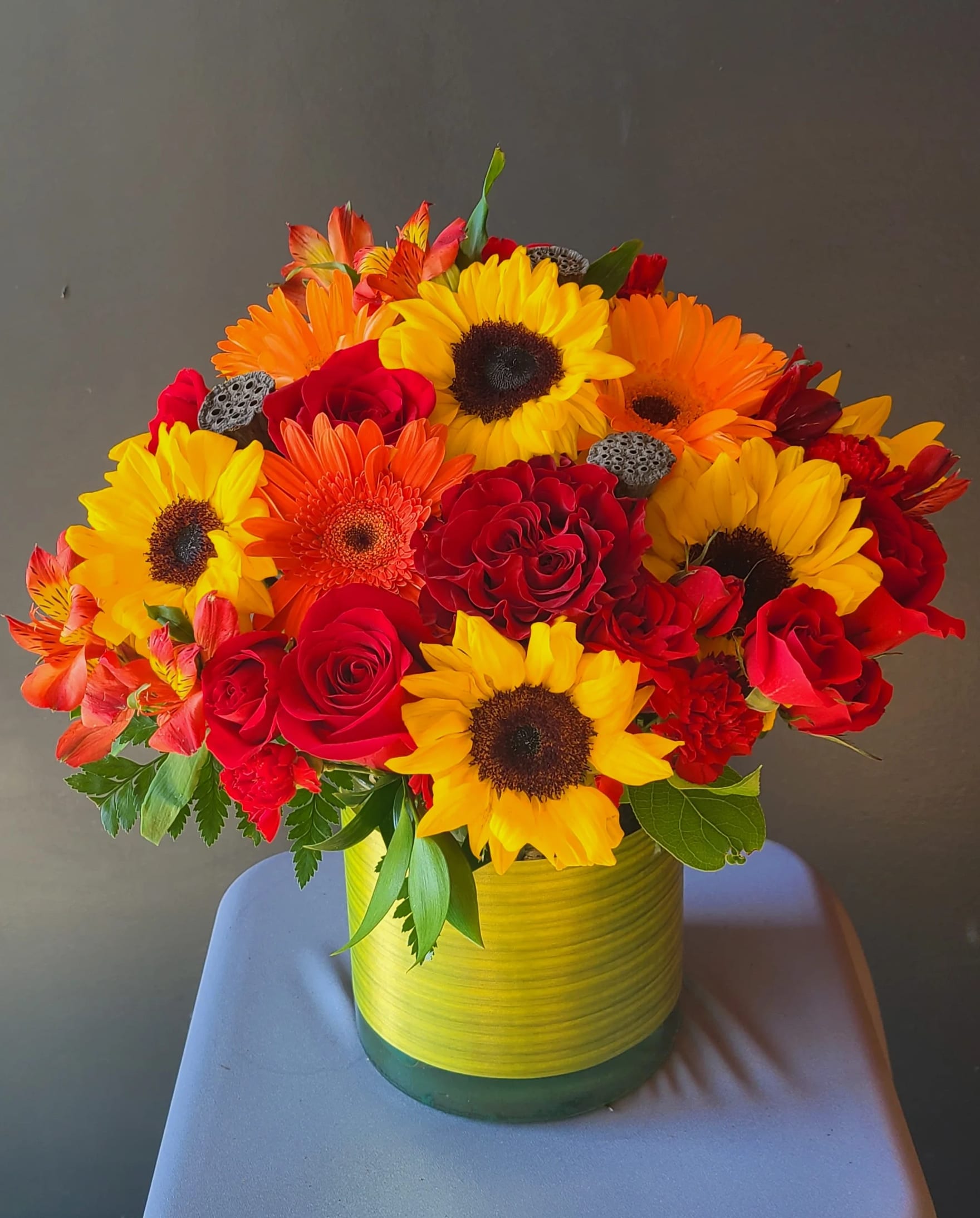 Darling Clementine - Warm and colorful, this arrangement of roses, gerberas, and sunflowers is perfect for showing your thanks or congratulations.