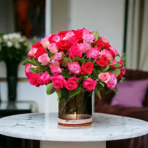 Love You Forever Roses 50ct - Featuring a harmonious blend of red and pink roses nestled amidst lush greens. Symbolizing deep affection and gratitude, each rose speaks volumes of the love shared between mother and child. With its rich hues and verdant accents, this bouquet is a heartfelt tribute to the enduring bond of maternal love.