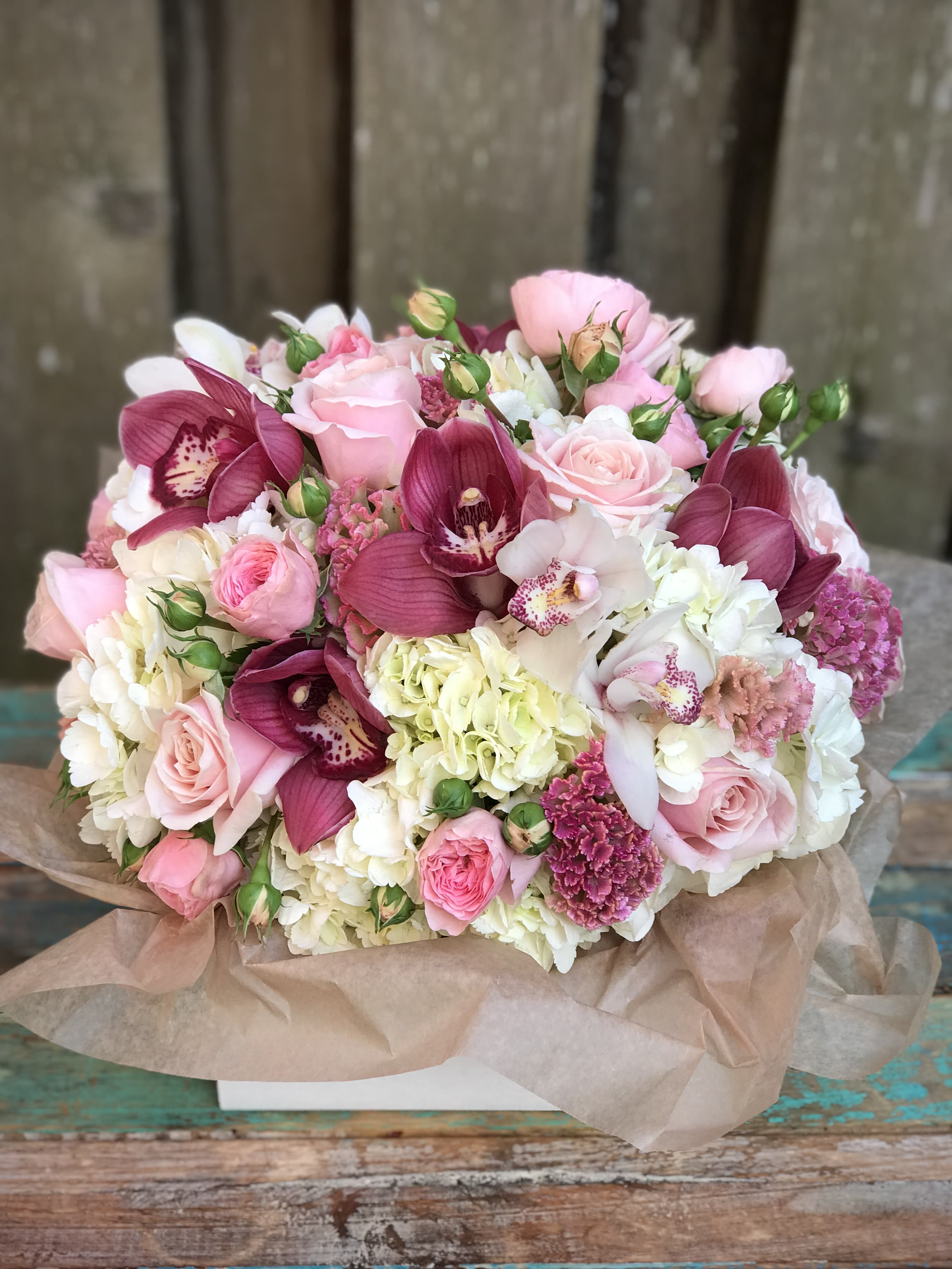Pink Glamour Pink Glamour - Lush and full, this arrangement is pretty in pink. Hydrangea, roses, orchids and more create a glamorous pop of pink color.