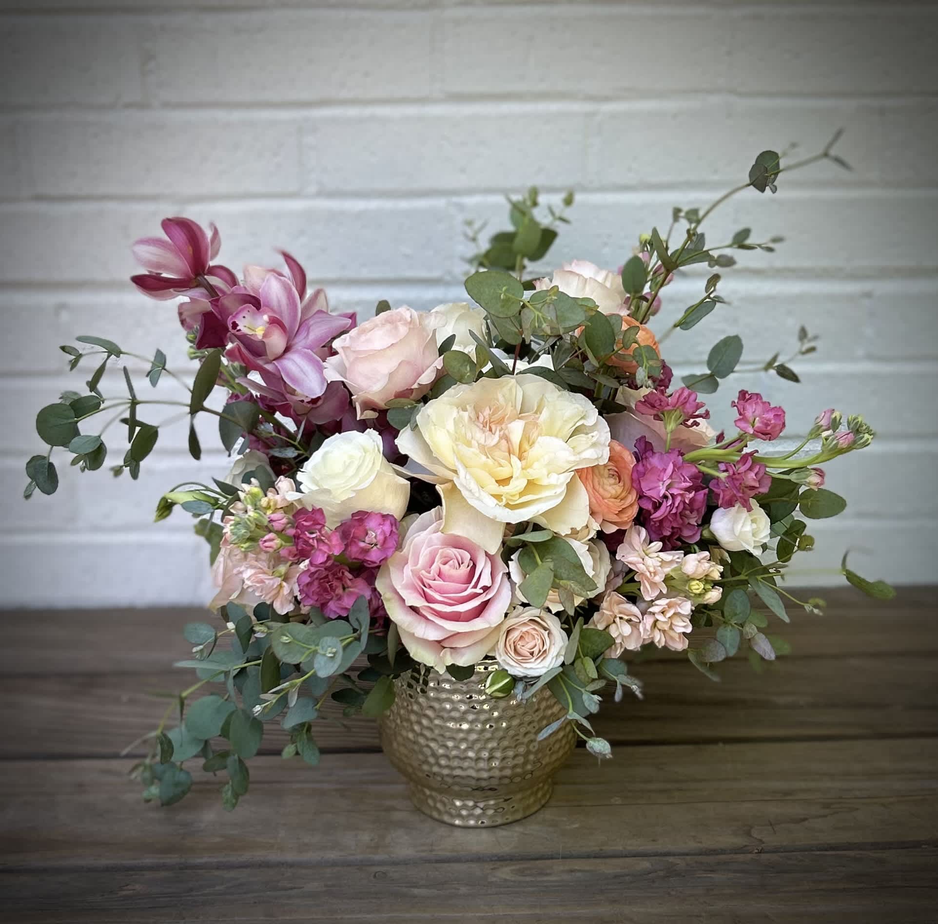 Pretty Princess Pretty Princess - Pretty pinks, luscious creams, blush and peach petals gathered in a glamorous vase. Vases may vary based on availability.