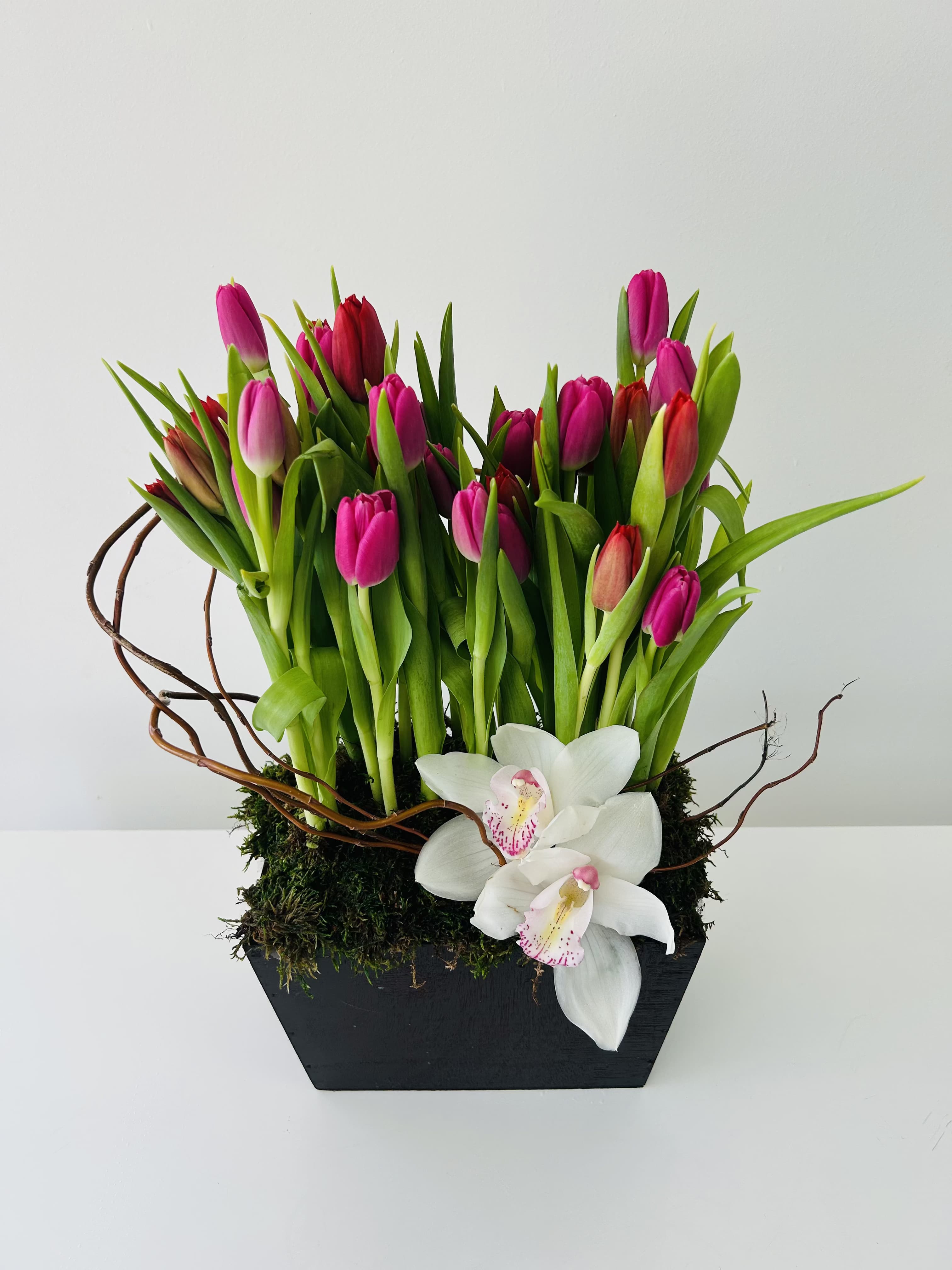 Holland - Designer arrangement of tulips and orchids in a unique keepsake vase. 