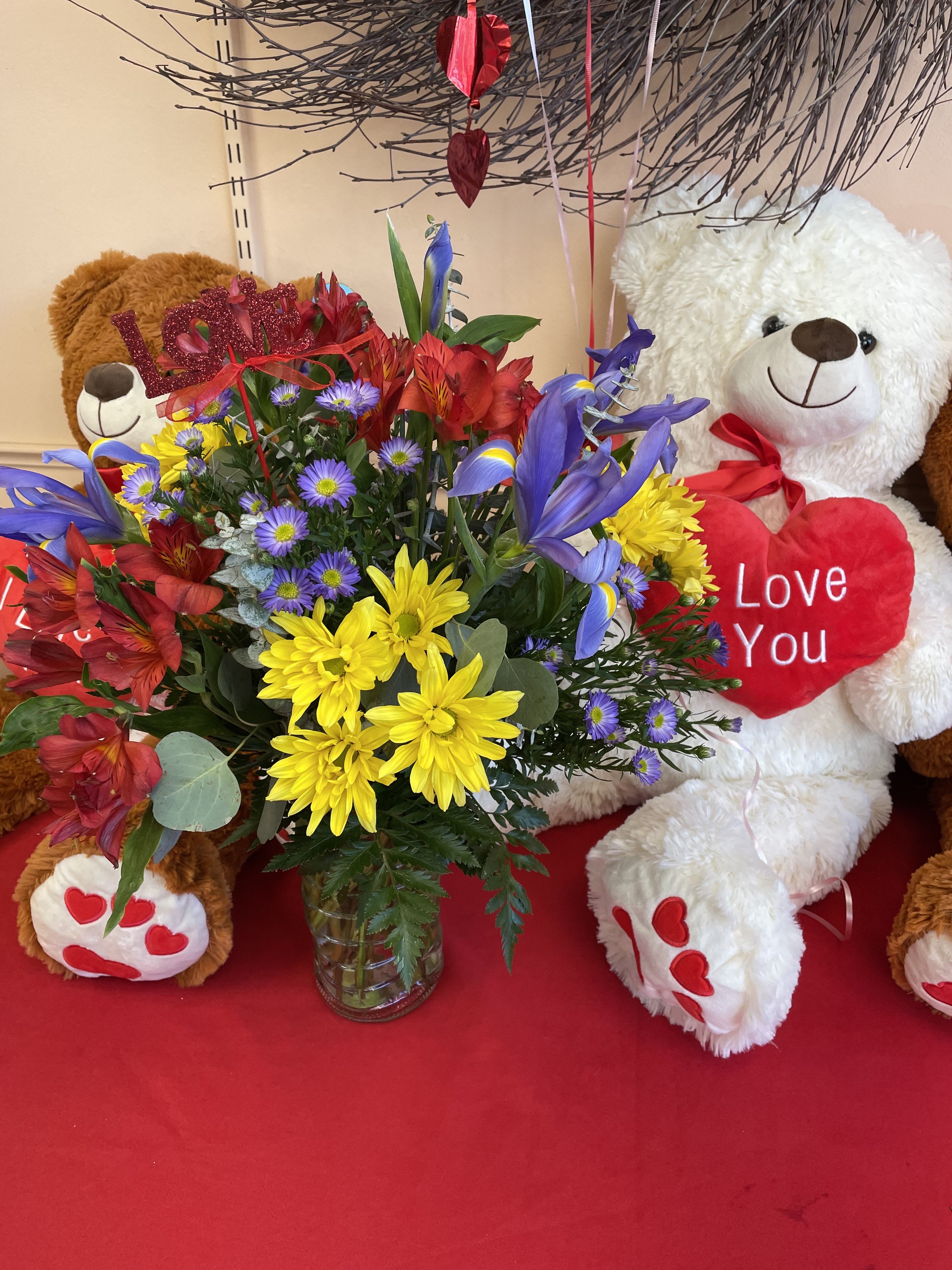 Love Actually Love Actually - A fun mix of Iris, Yellow Daisy, and Red Alstroemeria. *Bear available for additional.