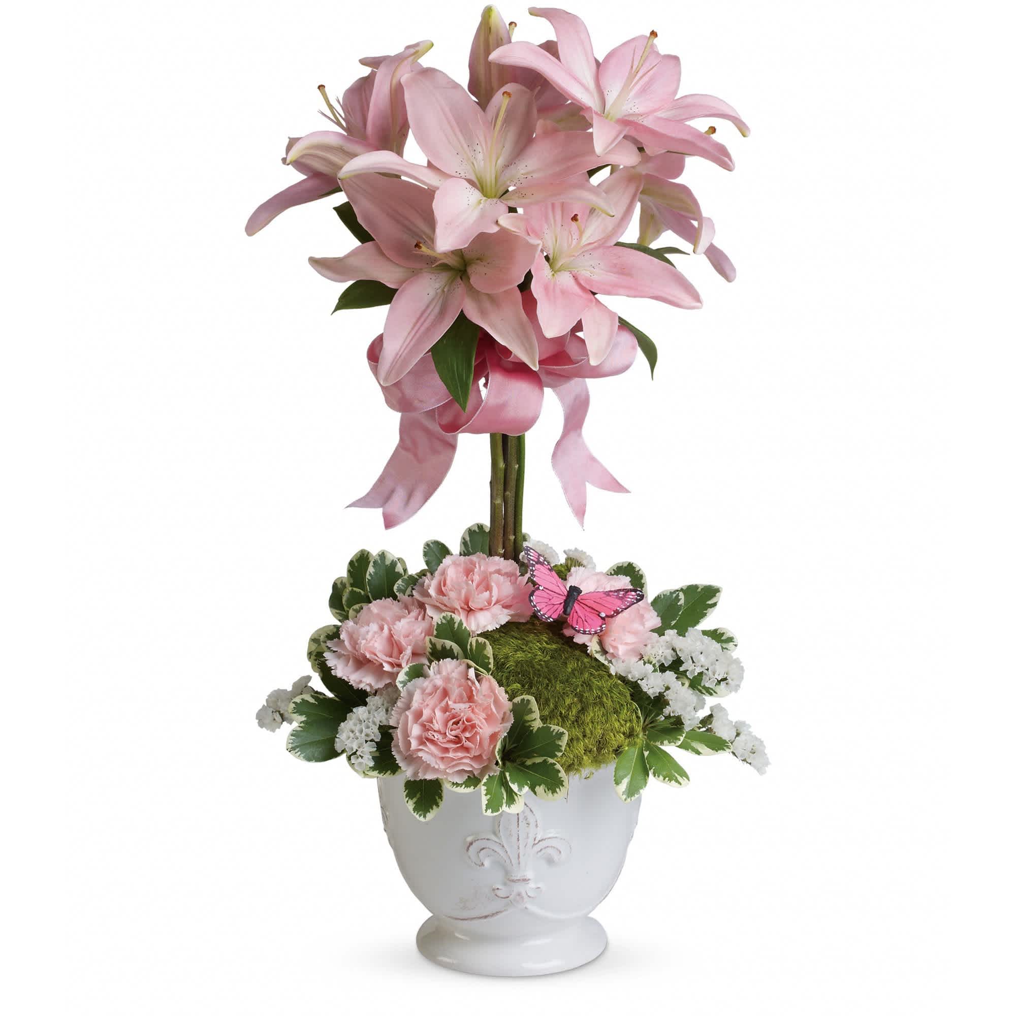 Teleflora's Blushing Lilies - Like springtime in Paris, this flirtatious topiary makes romance bloom! She'll adore the pale pink lilies, a pretty pink ribbon, and charming french country pot as well as the loving sentiment that comes with it!  