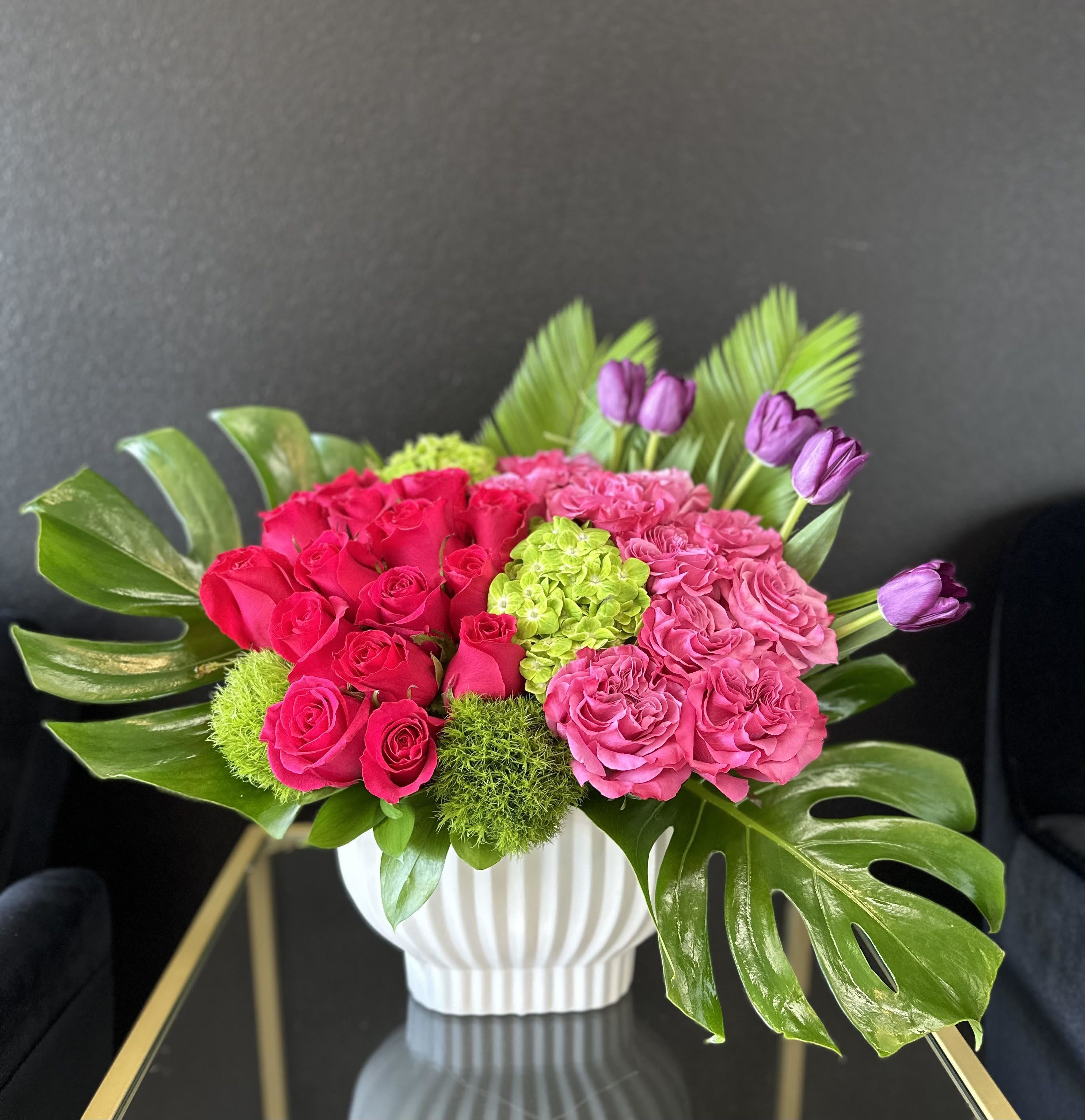Bright &amp; Lively  - This colorful, modern arrangement that contains garden roses,  hydrangeas, and  tulips is one-of-a-kind floral creation designed to delight. It is the perfect gift for to celebrate a birthday, new beginnings and even just because.  Arrangement Details: -Ceramic White Vase  -Custom Greeting Card -Care Instructions