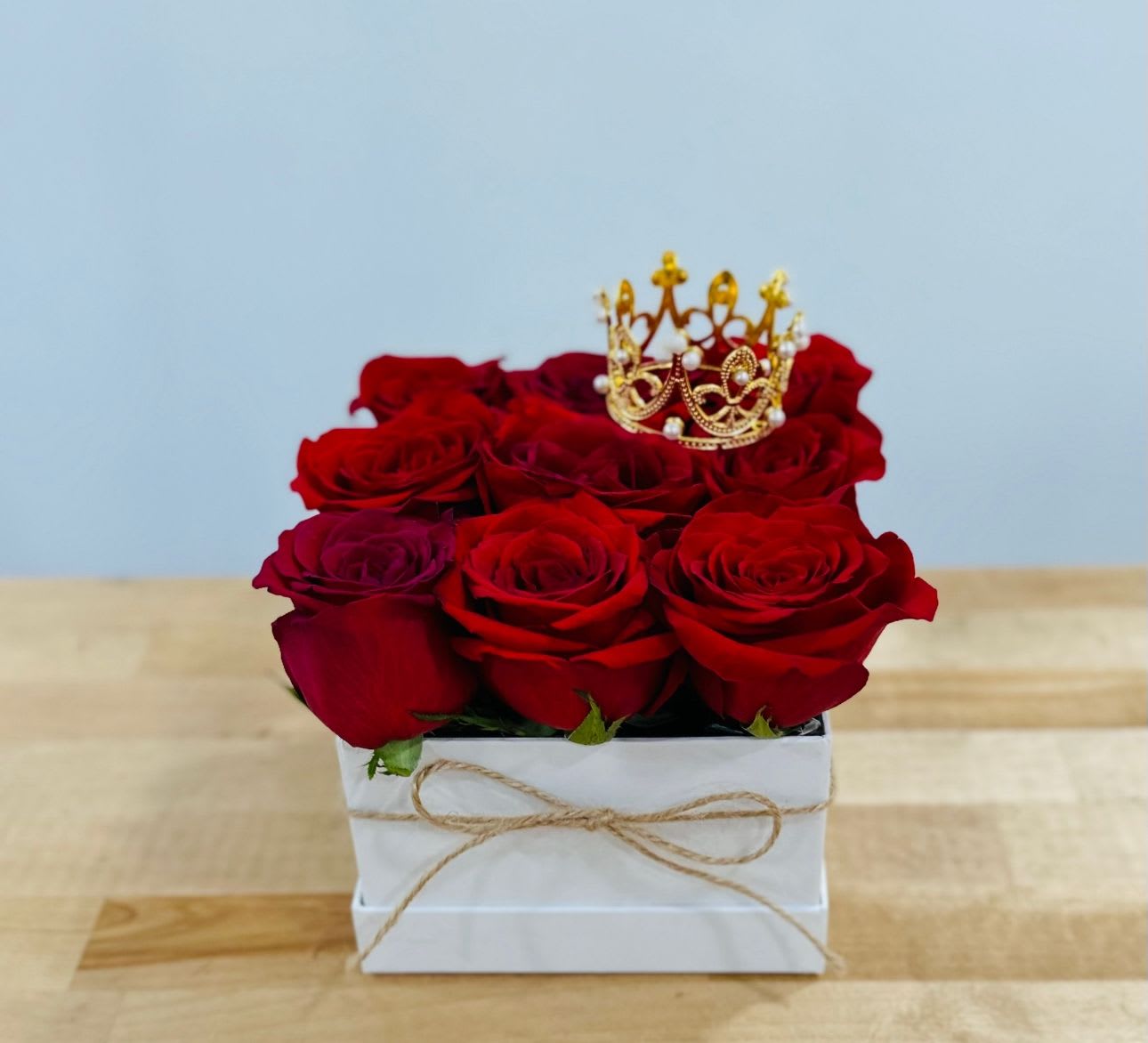 Simplicity Simplicity - This is a beautiful and captivating Arrangement with Fresh premium Red roses, crown topper and 3 red hearts filled with helium! For any kind of situation or moment this lovely one could melt any women’s heart!!