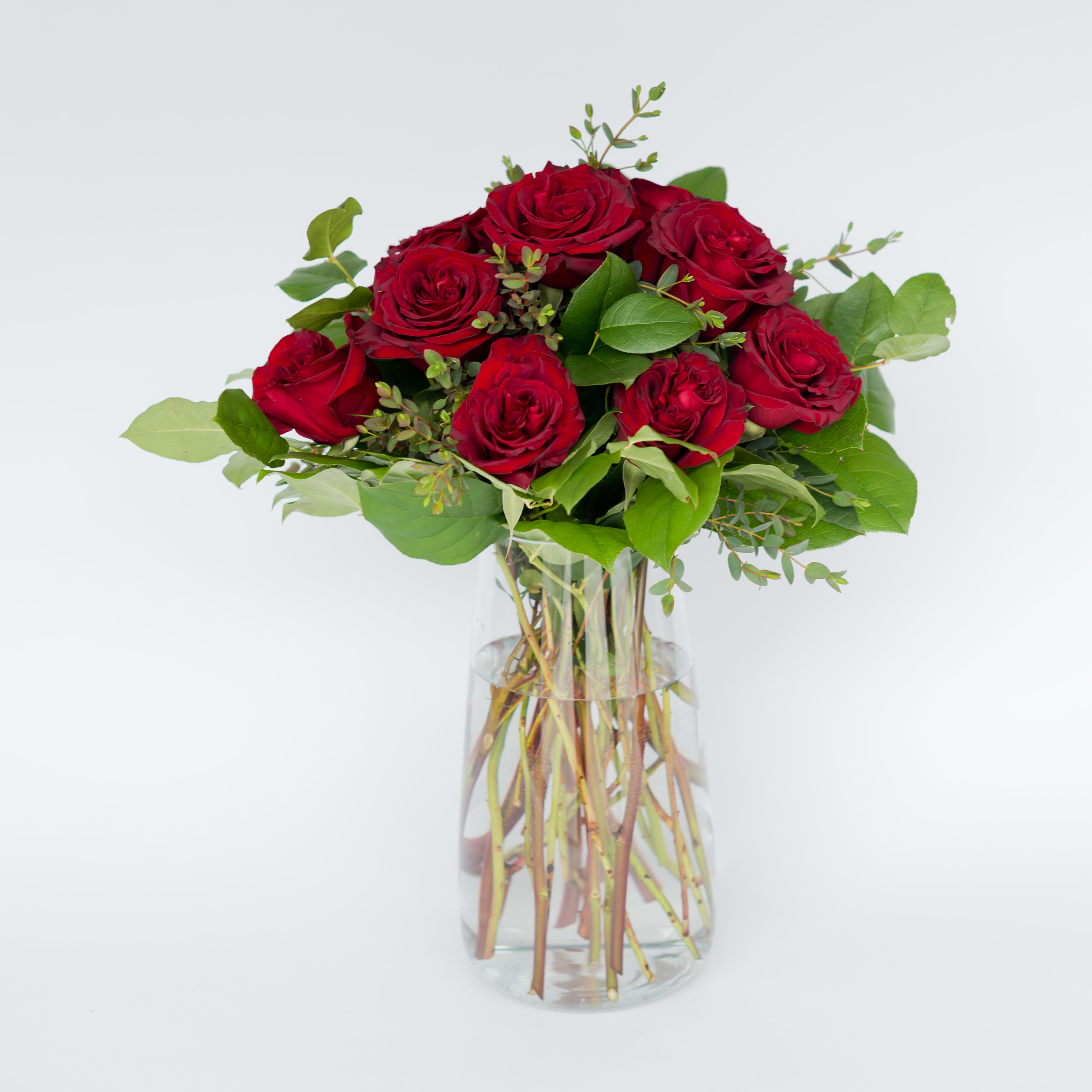 25 | moulin rouge 25 | moulin rouge - Classic red rose arrangement with foliage in a vase. Perfect for someone you love!