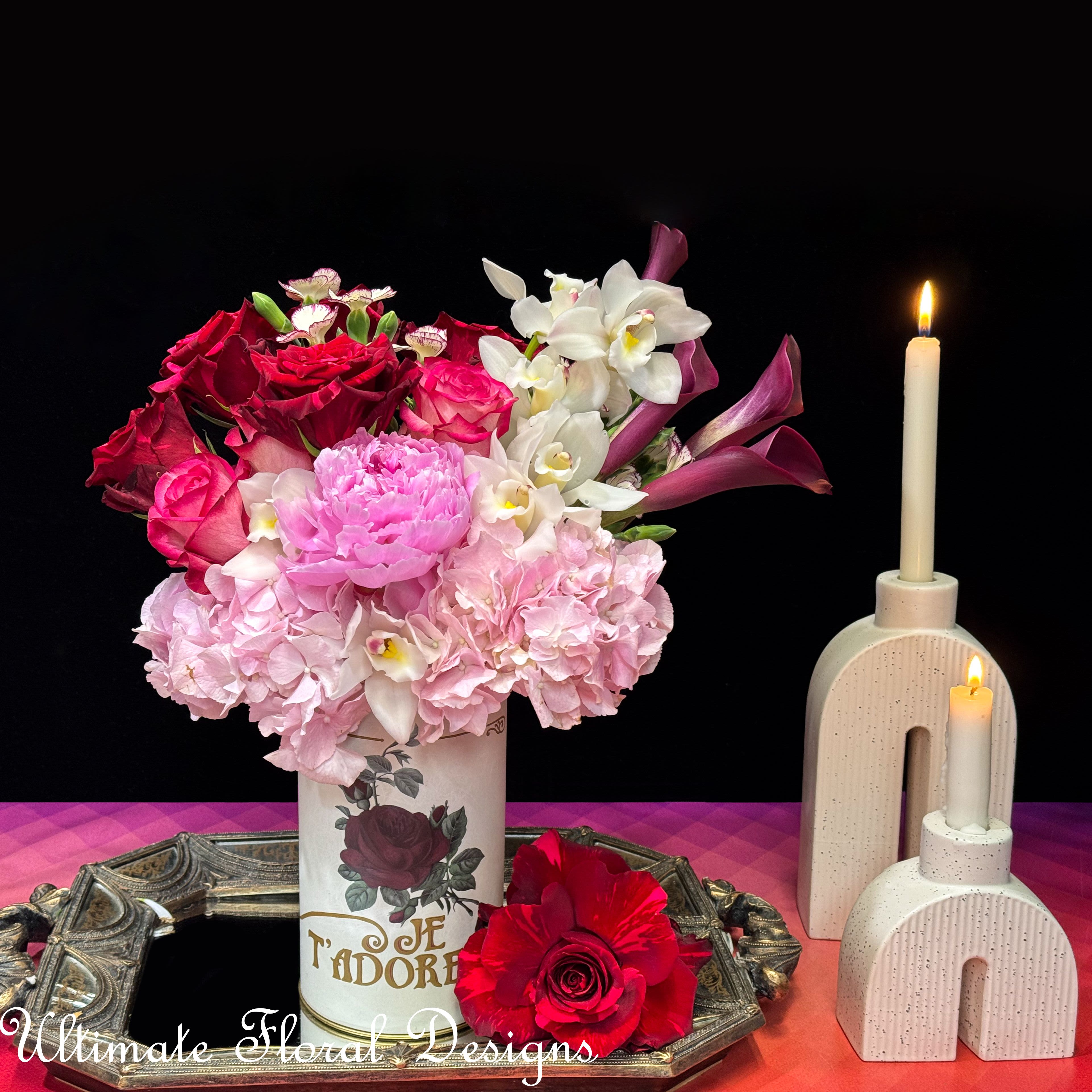Je T'adore Je T'adore - Je T'adore: A Romantic Floral Symphony A perfect expression of love and passion, this arrangement combines lush red roses, soft pink peonies, hydrangeas, and exotic cymbidium orchids. Housed in a vintage-inspired Je T’adore vase, this piece radiates romance and timeless beauty. The deep reds and blush pinks bring warmth and elegance, creating a stunning centerpiece for any special occasion. Let your flowers do the talking. #UltimateFloralDesigns #RomanticFlorals #LuxuryFloralDesign #JeTadore #RedAndPinkBlooms #TimelessElegance #CymbidiumOrchids #PeonyLove #DCFlorist #EventFlowers #FloralInspiration