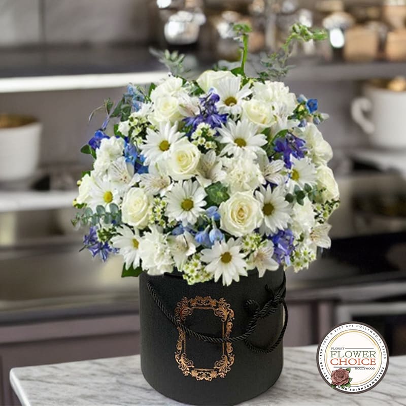 Midnight Elegance Flower Box - Embrace the enchanting allure of our &quot;Midnight Elegance&quot; Flower Box. This exquisite arrangement comes nestled within a sleek black flower box, beautifully contrasting against the pure elegance of delicate white flowers, featuring graceful roses and luscious hydrangeas. The harmonious blend of these pristine blooms exudes an air of sophistication, making it a perfect gift for any special occasion or a mesmerizing centerpiece for your own space. Let the timeless charm of the Midnight Elegance Flower Box captivate your senses and add a touch of refined beauty to your life.