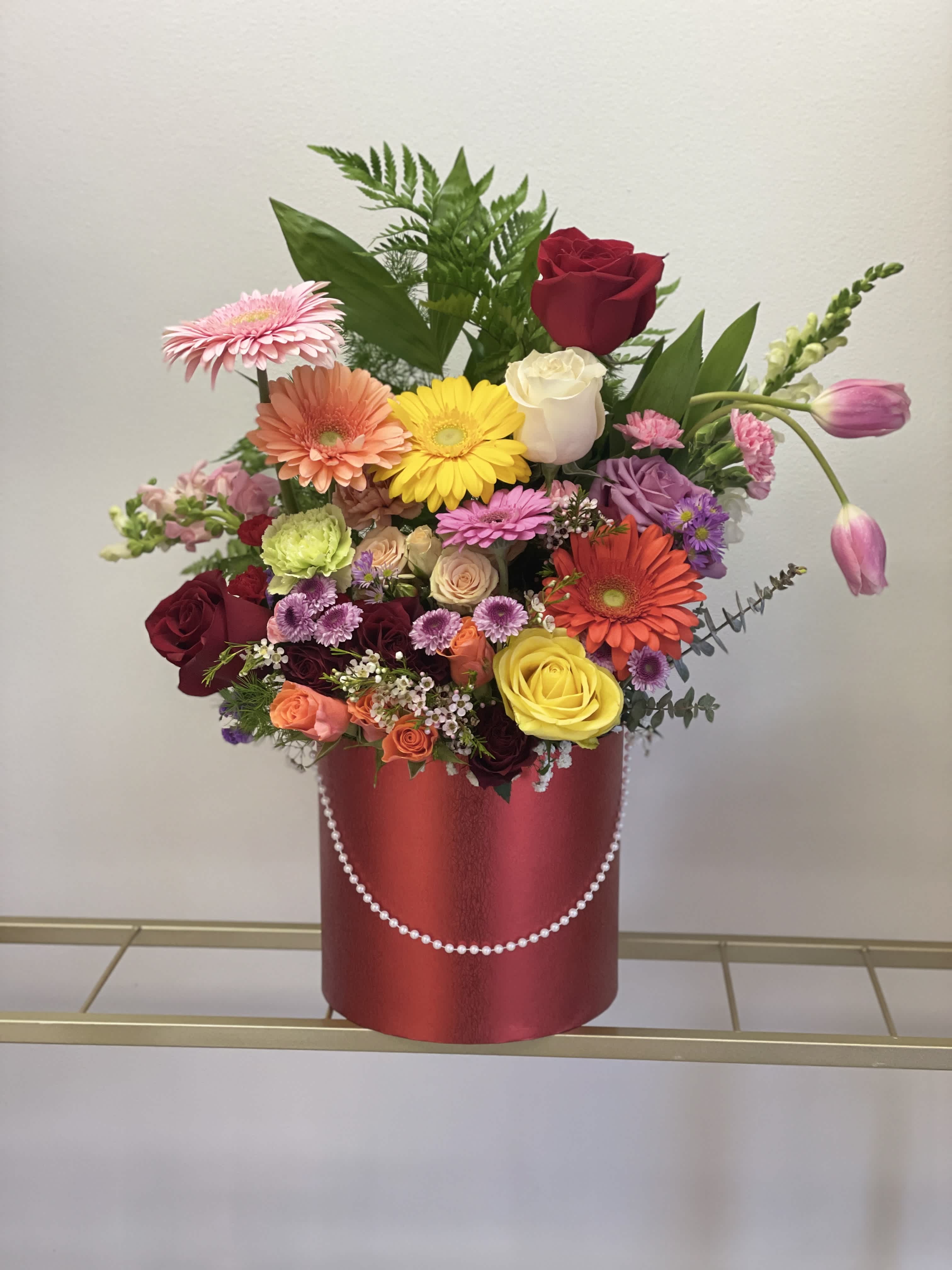 Happy Mothers Day Limited edition  - This beautiful arrangement is a limited edition for Mother's Day, only available for this event. It comes in a large red box filled with roses, spray roses, gerberas, tulips, carnations, eucalyptus, leather leaf, etc...